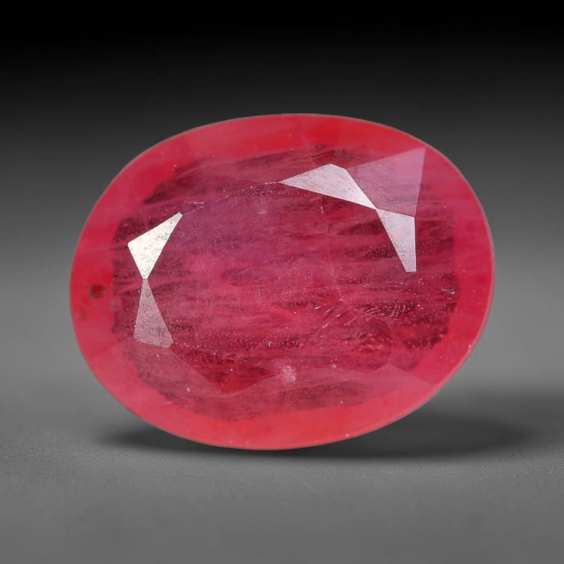 1.11 Carats Natural Orange Sapphire Oval Faceted Loose Gemstone, 94XM: This natural orange sapphire is cut into a balanced oval brilliant faceted form, showcasing soft warm orange-pink hues characteristic of natural corundum material. Fine scattered mineral pinpoints and