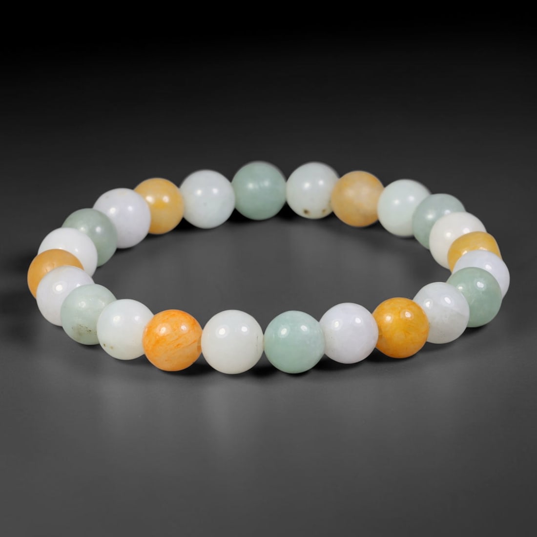 Natural Burmese Type A Multi-Colour Jadeite Jade Beaded Bracelet, 66TA: Strung from untreated natural Burmese Type A jadeite jade spherical beads with maximum bead dimension of 8.15mm, this bracelet strand features a sleek smooth polished finish showcasing mixed pale gree