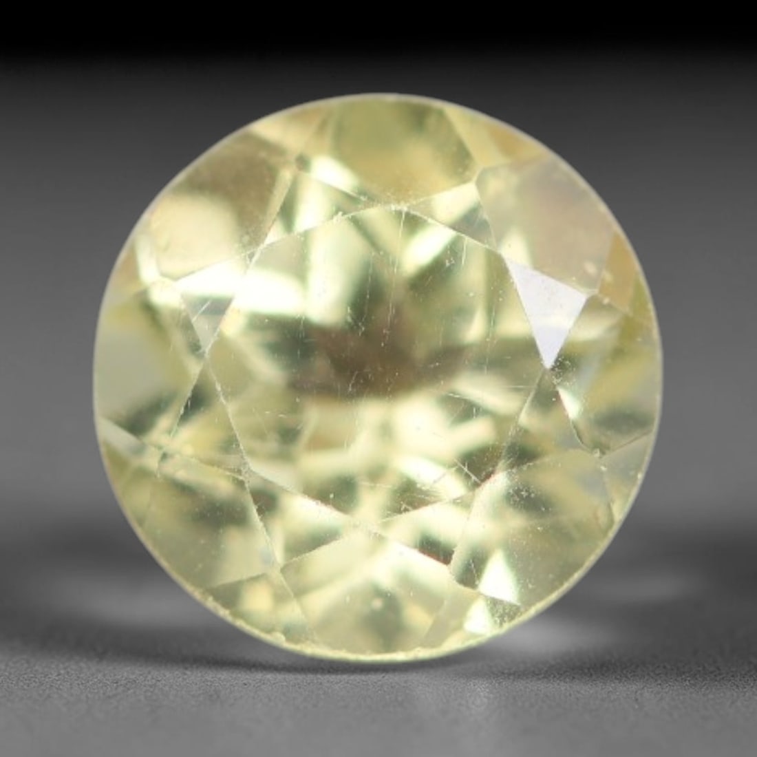 1.49 Carats Natural Pale Yellow Apatite Faceted Loose Gemstone, 39XY: This apatite specimen is sourced from natural geological deposits and shaped with professional faceting and high-gloss polishing work across the outer facet surfaces. Minute internal mineral inclusion