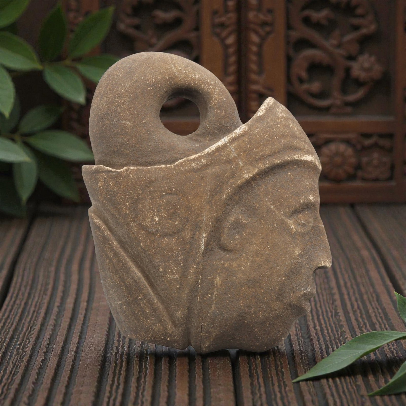 Ancient Tribal Stone Amulet - Anthropomorphic Head Ornament, 18WT: Carved stone pendant depicting a human head in profile, worked from a single piece of brown stone with natural patina and surface wear. The face features defined, incised eyes, nose, and mouth, with a