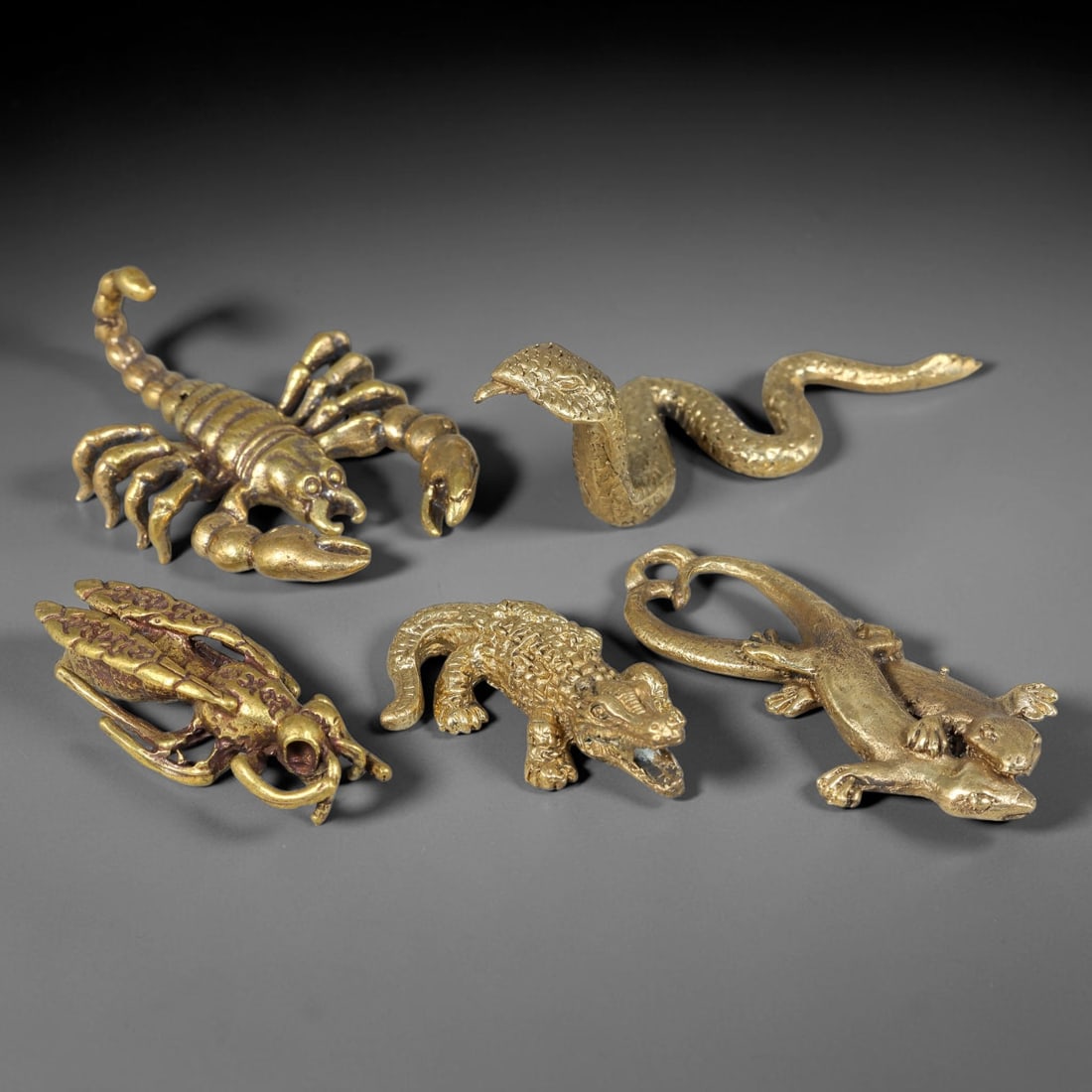 Thai Vintage Copper Alloy Sacred Reptile & Scorpion Devotional Figures - 5pcs Set, 9YZ: Cast copper alloy miniatures with warm aged gilded patina forming a five-piece Thai votive animal grouping, sculpted as scorpion, cobra, shrimp, crocodile, and dual gecko talisman with integrated susp