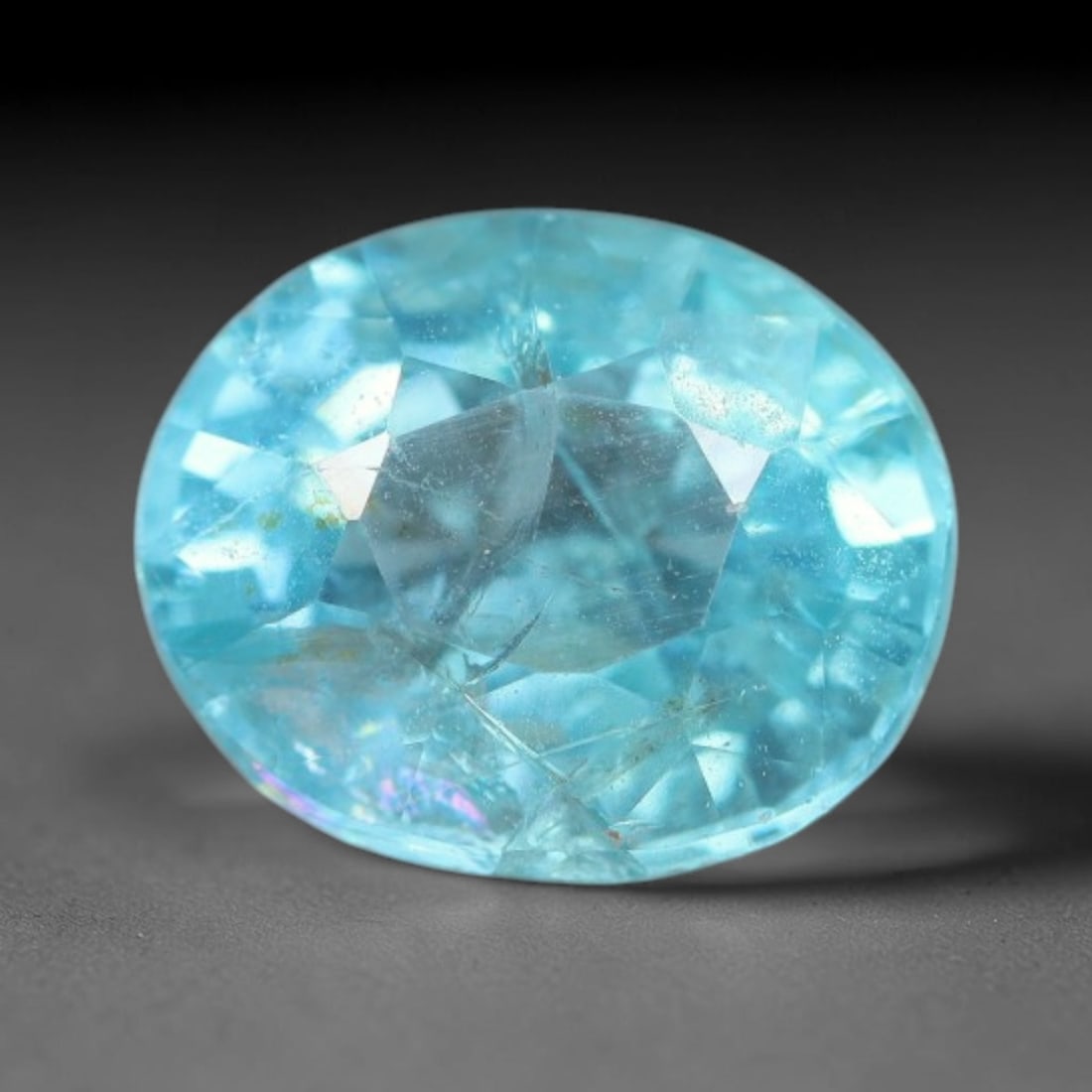 1.28 Carats Natural Bright Cyan Blue Apatite Oval Faceted Loose Gemstone, 17WW: This apatite is sourced from natural mineral deposits and processed with precise faceting and uniform high-gloss polishing by professional lapidary craftsmanship. Natural fibrous textures and tiny sca