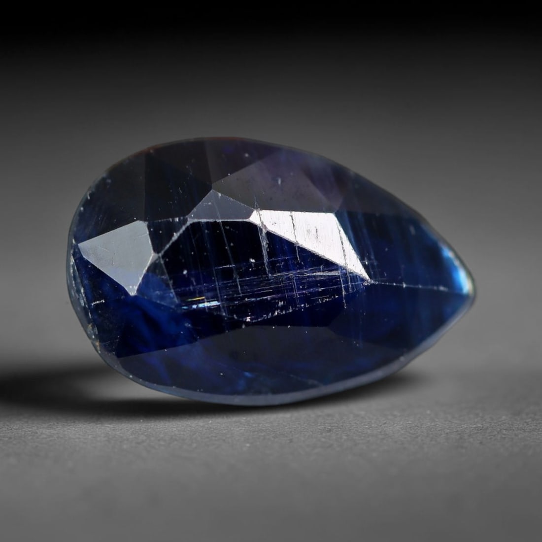 1.01 Carats Natural Deep Blue Pear Shape Kyanite Gemstone, 42XZ: I'm happy to present this nice single faceted kyanite cut into a sleek pear teardrop shape with striking rich color. This stone measures 7.0x5.7x4.0mm and weighs 1.01 carats total. It holds a deep, sa