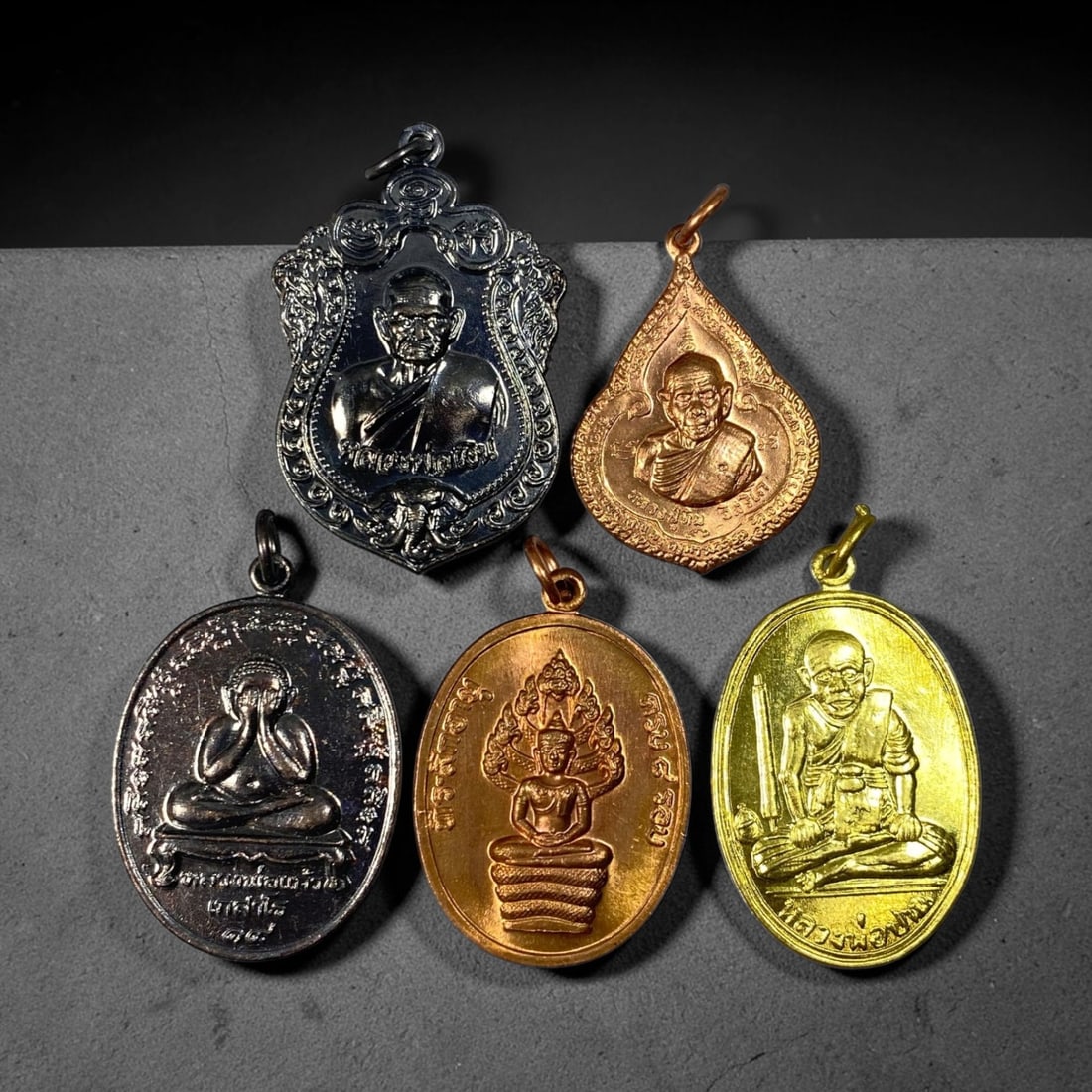 Thai Vintage Mixed Metal Buddhist Monk & Buddha Amulets - 5pcs Set, 22YZ: This five-piece grouping consists of vintage Thai devotional pendants cast in varied silver-toned alloy, copper, and brass gilded metals, each fitted with a fixed suspension loop for wearable talisman