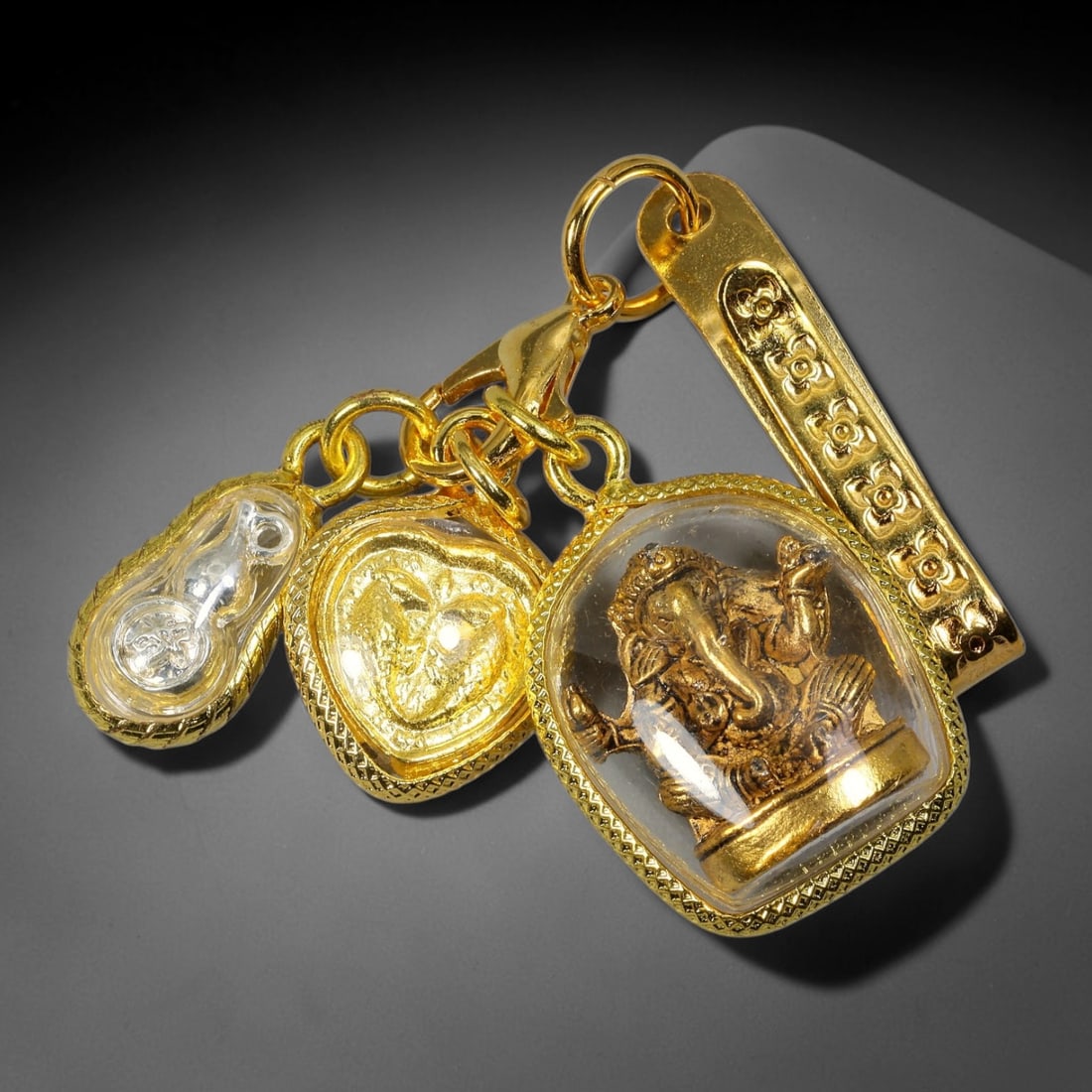 Three Charms Thai Amulet Set with Floral Embossed Gold Clip, 25YY: Triple pendant Thai spiritual charm set linked by lobster claw clasp and gold jump rings, paired with a long floral embossed gold clip for convenient attachment to bags, belts or car mirrors. The thre