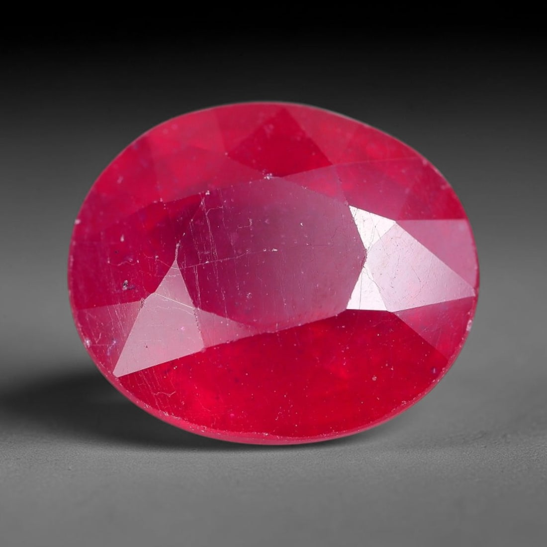 7.42 Carats Natural Madagascar Ruby Oval Faceted Loose Gemstone, 44XM: This sizable natural Madagascar ruby is cut into an oval brilliant faceted form, showcasing rich saturated crimson red hue characteristic of Malagasy corundum. Extensive natural internal silk veining,