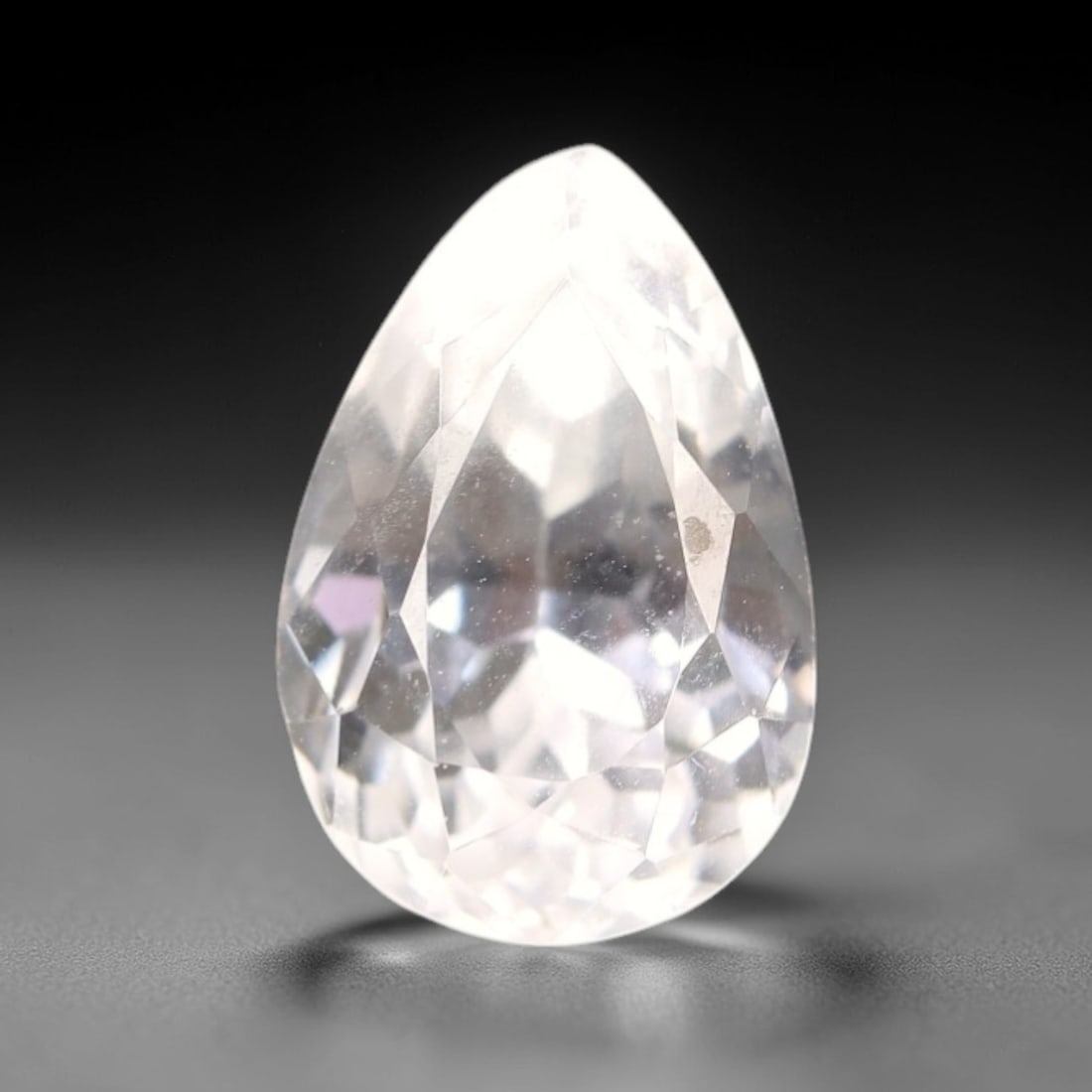 5.43 Carats Ice White Kunzite Pear - Natural Afghan Stone, 27XP: This ethereal pear-cut kunzite glows with a delicate ice-white hue, suffused with subtle undertones of pale lavender that catch the light to reveal a soft, milky translucence. The faceting pattern is 