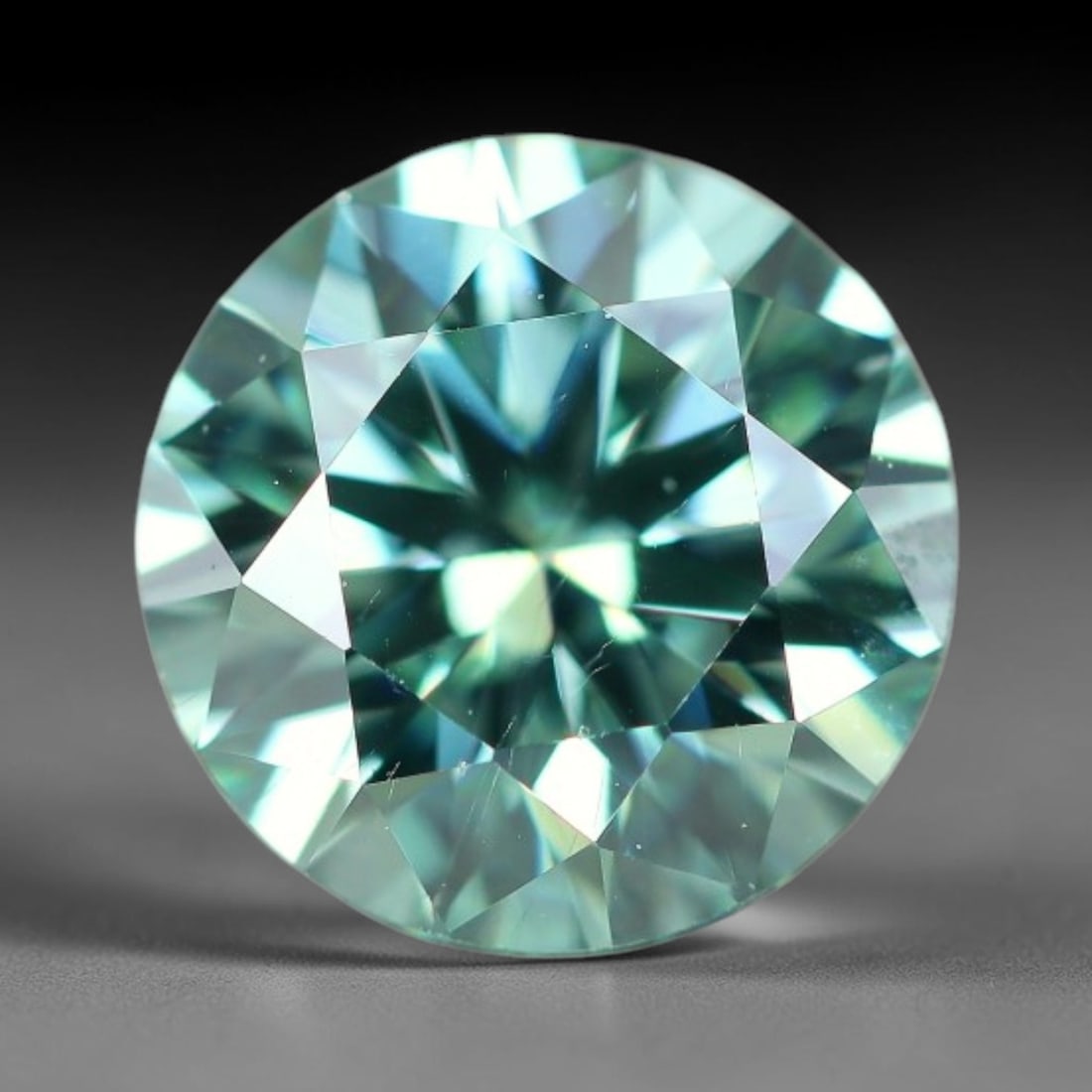 0.96 Carats Natural Green Toned Moissanite Loose Gemstone, 58WP: This lab grown moissanite measures 6.2x4mm, crafted from silicon carbide material well known for exceptional refractive index that generates bright, multi-faceted light dispersion in all lighting envi