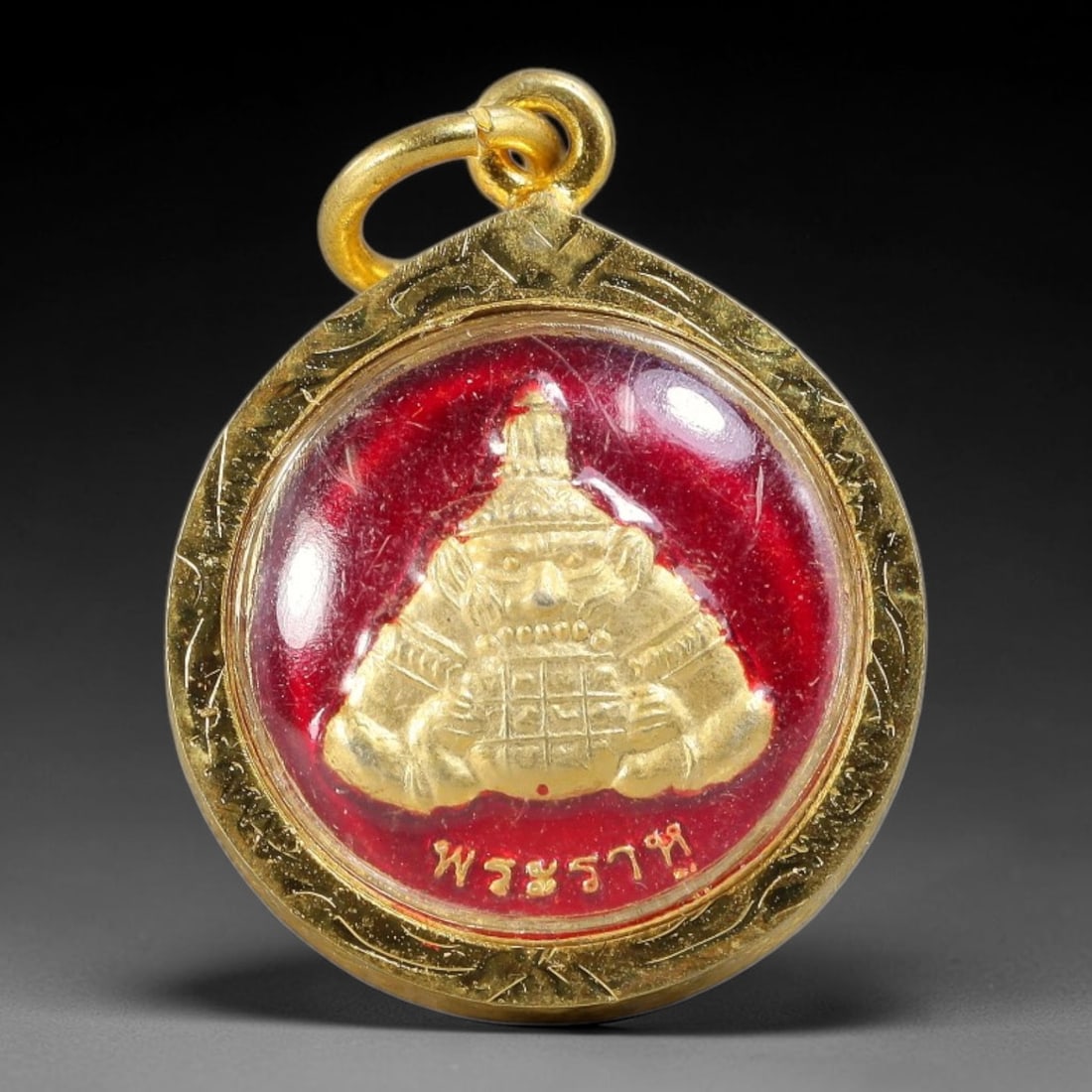 Thai Round Rahu Red Enamel Dual-Sided Gold Plated Metal Casing Amulet, 54YY: Round dual-sided Thai Rahu deity amulet set inside hand-carved leaf pattern golden frame with clear transparent protective cover. The front showcases embossed golden Rahu god relief against vivid glos