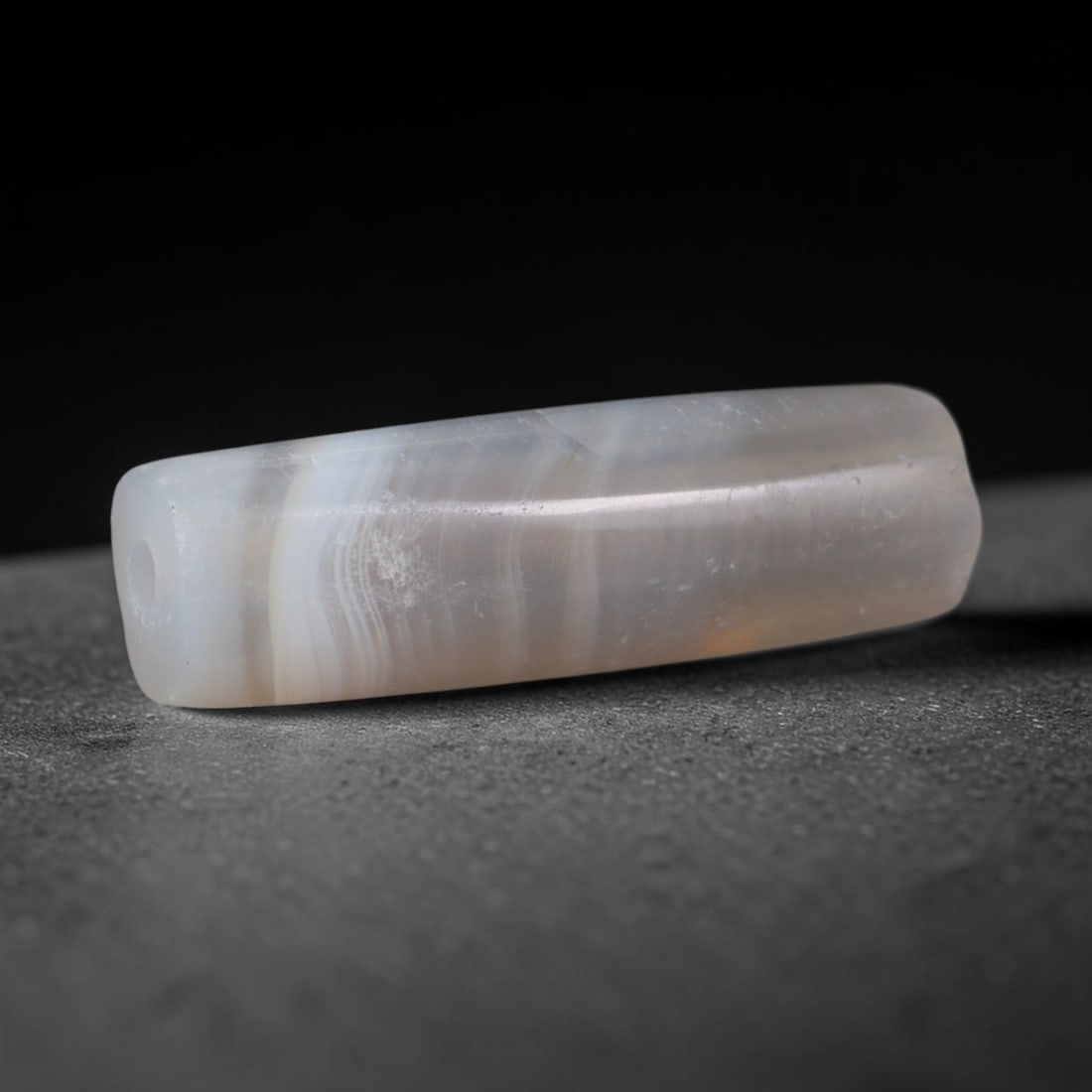 Ancient Roman Republic & Imperial Roman Banded Agate Cylinder Bead (509 BCE-476 CE), 74XD: This antique slender cylindrical banded agate bead originates from Roman Republic & Imperial Roman culture, a Mediterranean civilization that mass-produced layered chalcedony beads for provincial trad