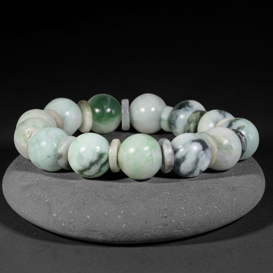 Natural Burmese Type A Mixed Green Cloud Mottled Jadeite Jade Bead Bracelet, 9TP: Strung from natural Type A Burmese jadeite, this large spherical bead bracelet combines soft pale celadon, bright emerald green and dramatic blackish-grey cloud mottling, accented with thin multi-tone