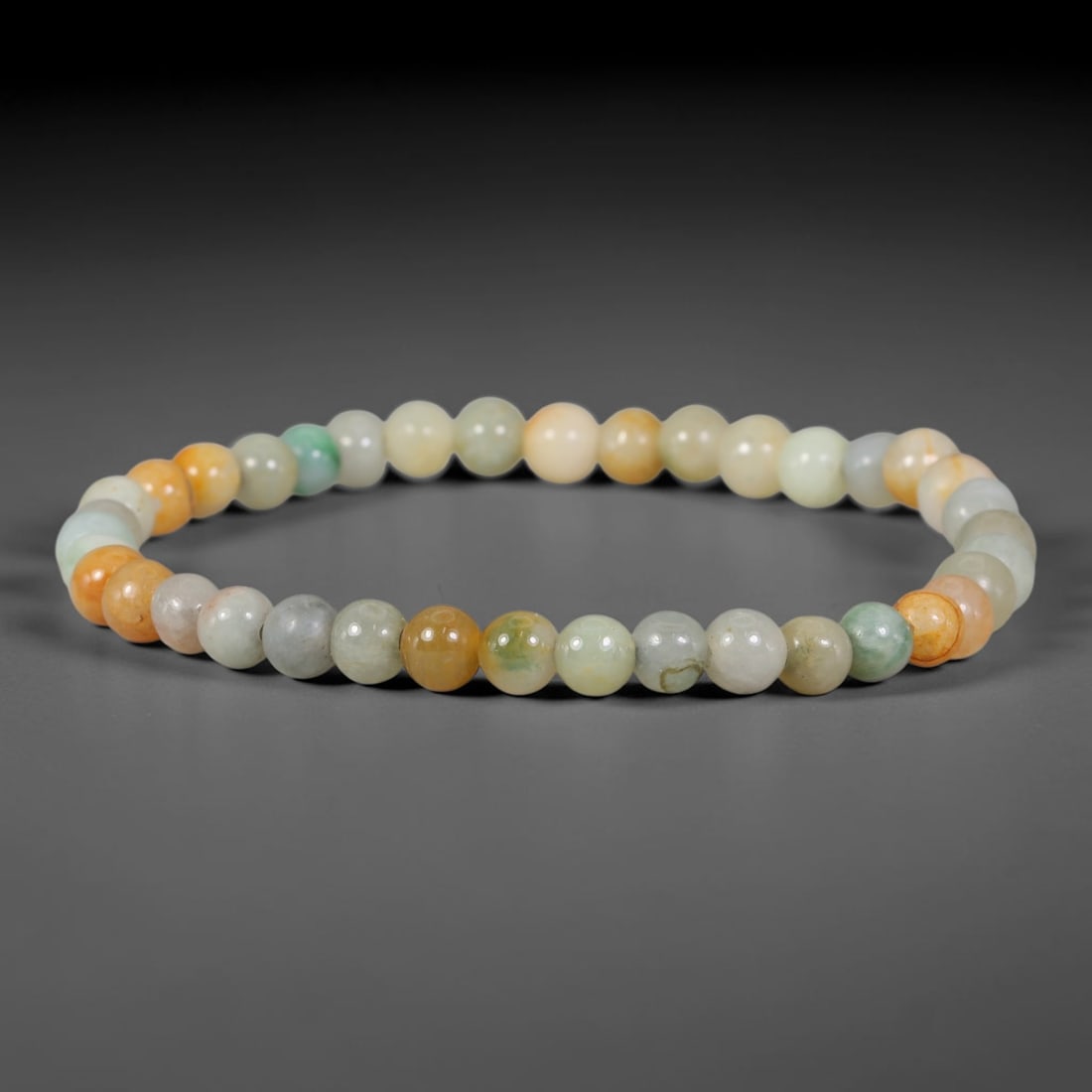 Natural Burmese Type A Soft Multicolour Pastel Round Jadeite Jade Beaded Bracelet, 43TP: Polished elastic strand bracelet hand-strung with genuine untreated Type A Burmese jadeite round beads, showcasing gentle pastel hues of milky white, pale celadon green and warm honey-amber orange. Na