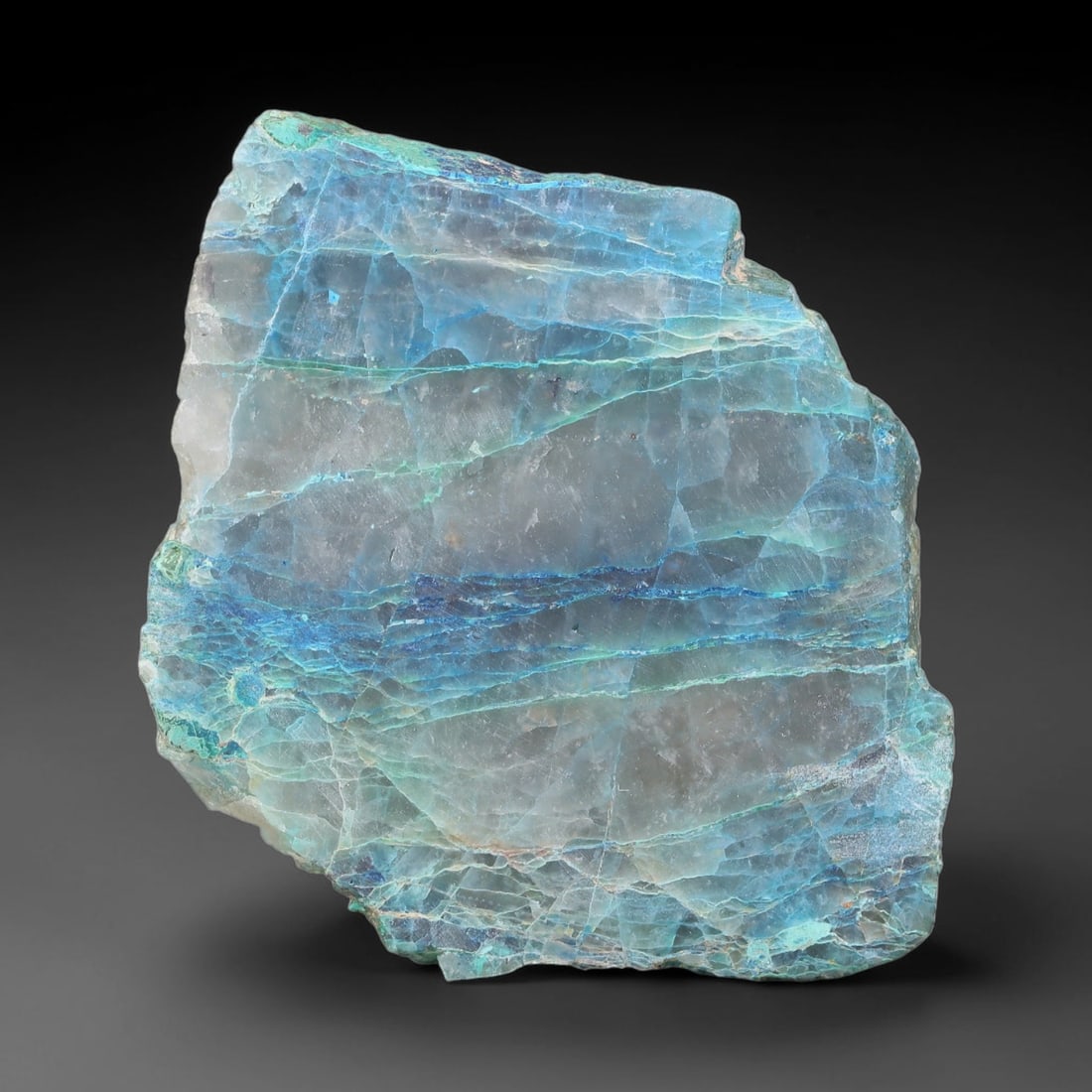 114.62ct Natural Peruvian Chrysocolla Polished Slab Rough, 88YS: This partial-polished chrysocolla slab features blended mineral matrix with smooth refined face and unaltered natural rugged edge across its 52x40x6mm elongated form, translucent mineral layers hold s
