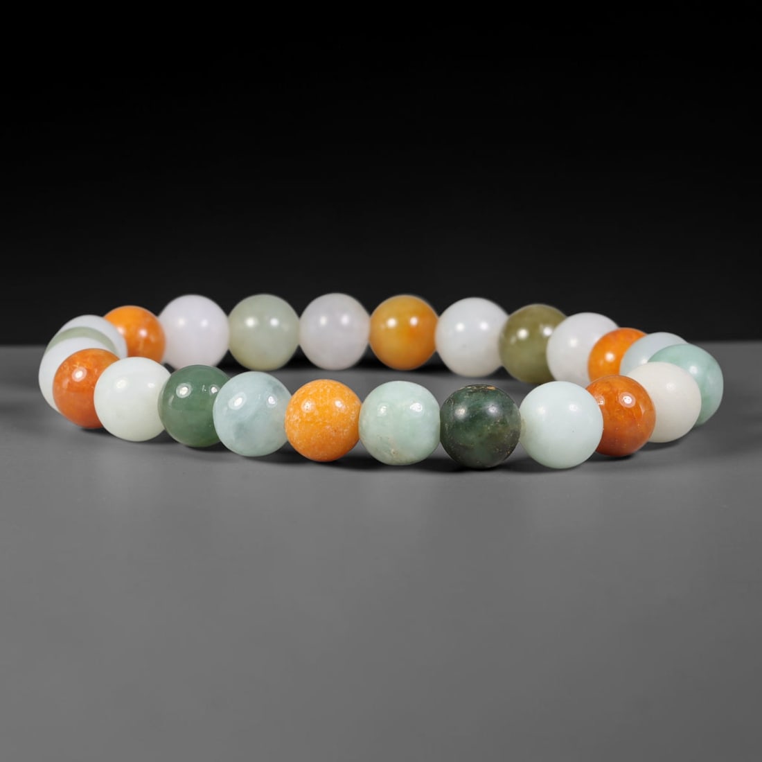 Natural Burmese Type A Multi-Tone Orange Green White Jadeite Jade Bead Bracelet, 2TP: Strung from natural Type A Burmese jadeite, this spherical bead bracelet features a vibrant mix of creamy white, pale celadon, deep forest green and warm tangerine orange beads. Each bead is evenly fo