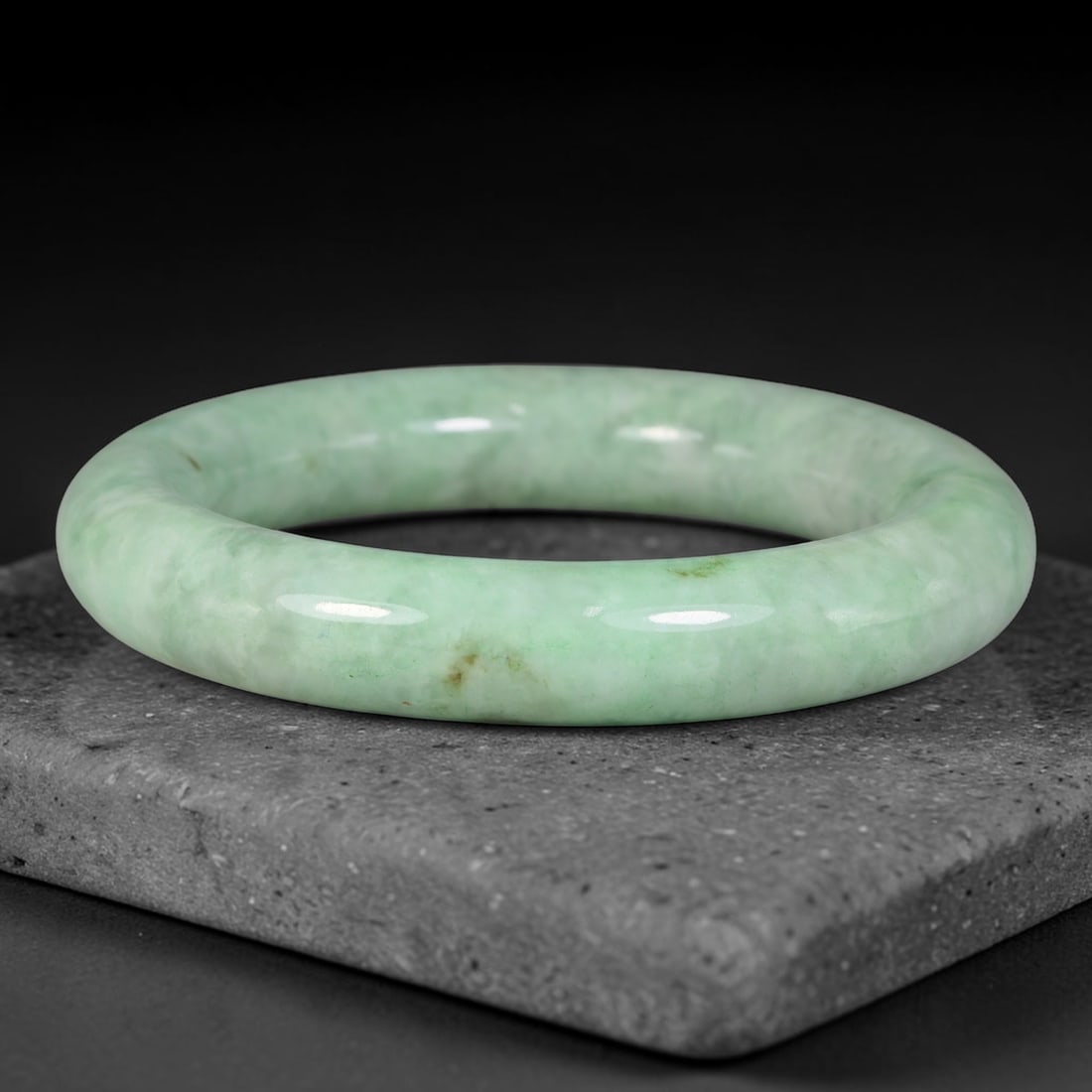 Natural Burmese Type A Pale Cloudy Green Jadeite Jade Bangle Bracelet, 78TD: Crafted from natural Type A Burmese jadeite, this substantial rounded bangle carries a soft pale cloudy green tone with faint natural mineral flecks across its smoothly polished surface. It is formed 