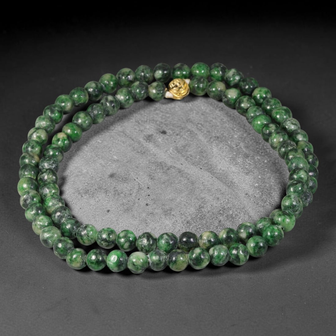 Natural Burmese Type A Deep Spinach Green Mottled Round Jadeite Jade Beaded Necklace, 47TF: Hand-strung bead necklace made of genuine untreated Type A Burmese jadeite round beads, showcasing a rich deep spinach green hue accented with natural mottled dark green inclusions throughout. It is f