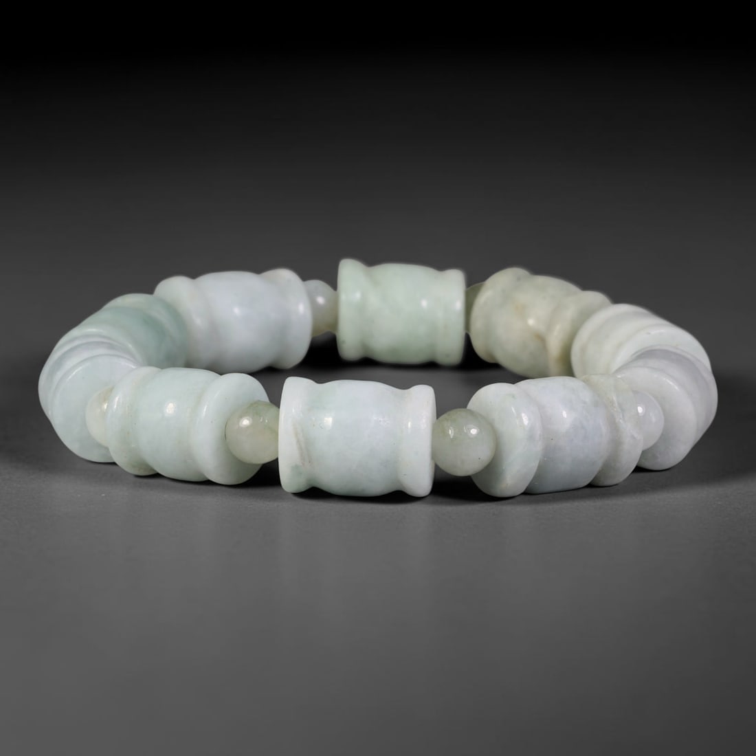 Natural Burmese Type A Carved Waisted Barrel Jadeite Jade Bead Bracelet, 13TP: Strung from natural Type A Burmese jadeite, this bracelet features carved waisted barrel beads in soft pale milky celadon with faint diffused green undertones, separated by small round jadeite spacer 