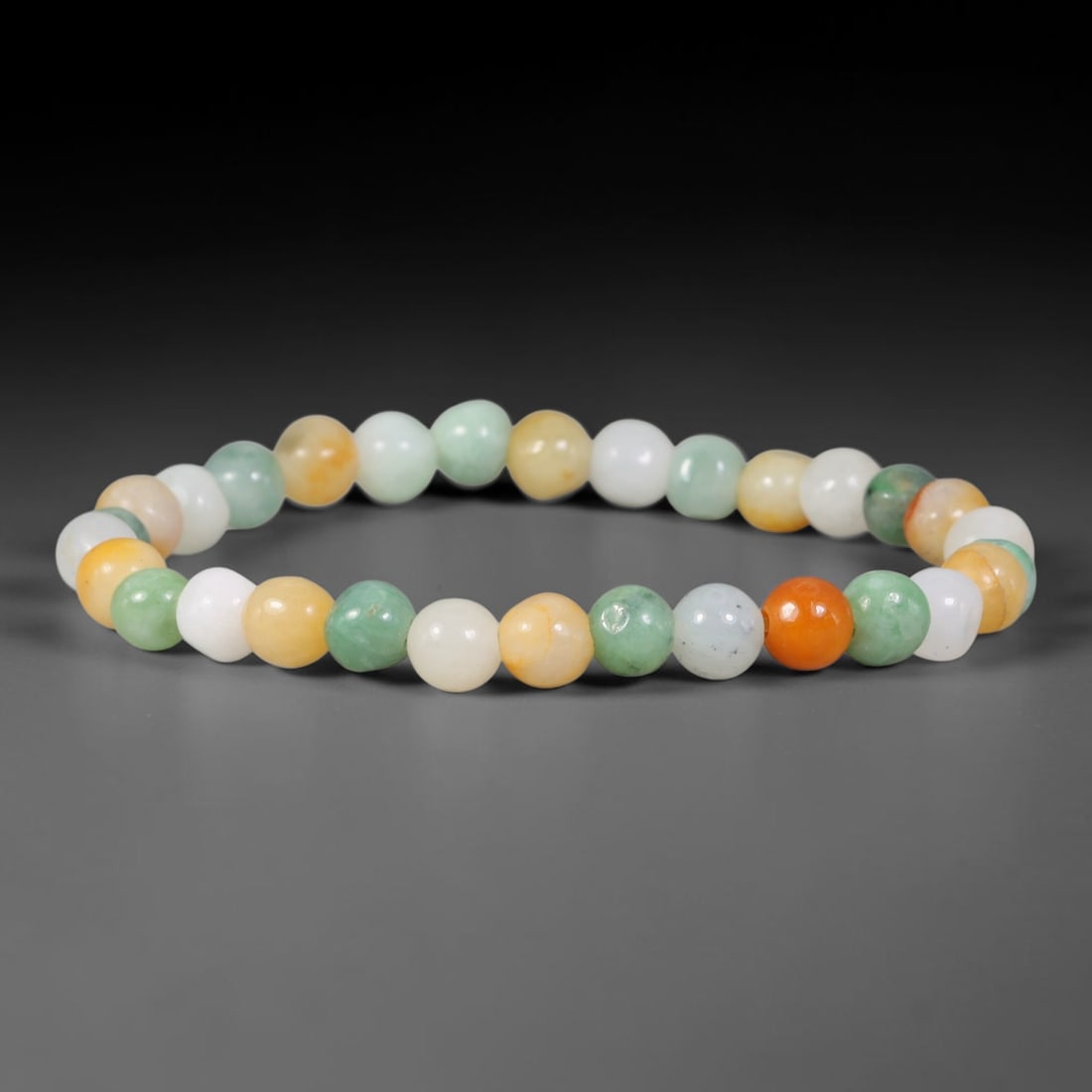 Natural Burmese Type A Multicolour Tri-Color Round Jadeite Jade Beaded Bracelet, 47TP: Polished elastic strand bracelet hand-strung with genuine untreated Type A Burmese jadeite round beads in a soft tri-color palette of pale celadon green, milky white and warm golden-orange. Each bead 