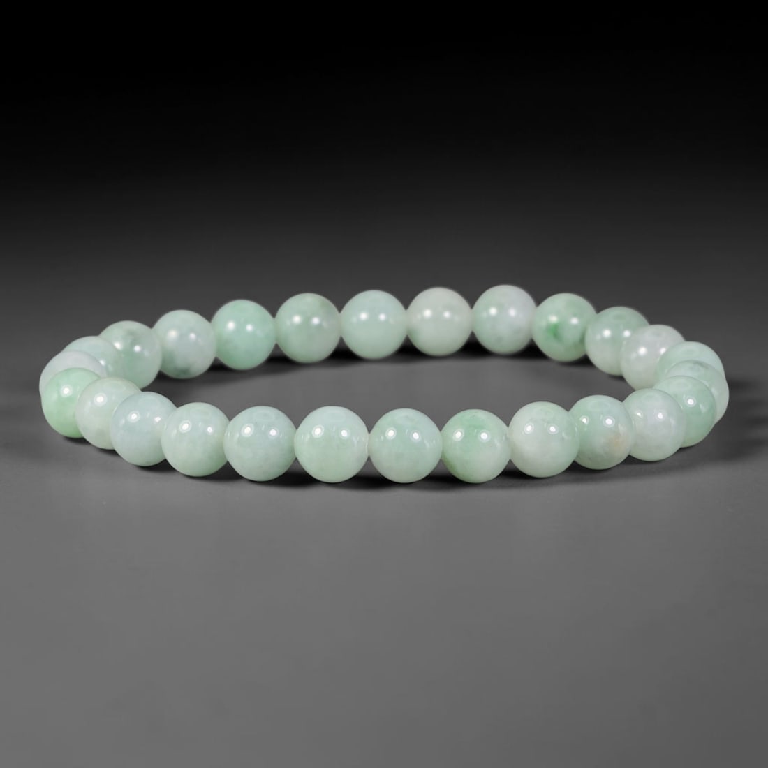 Natural Burmese Type A Pale Celadon Floating Green Jadeite Jade Bead Bracelet, 37TP: Strung from natural Type A Burmese jadeite, this slender spherical bead bracelet features a soft pale celadon base with delicate floating green flecks scattered across the beads. Each bead is smoothly