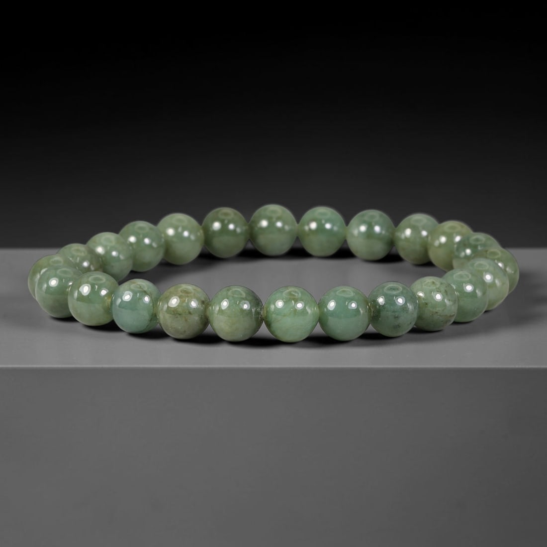 Natural Burmese Type A Deep Olive Green Jadeite Jade Bead Bracelet, 29TP: Strung from natural Type A Burmese jadeite, this spherical bead bracelet features rich deep olive green tones with subtle natural mineral speckles and faint veining throughout. Each bead is smoothly p