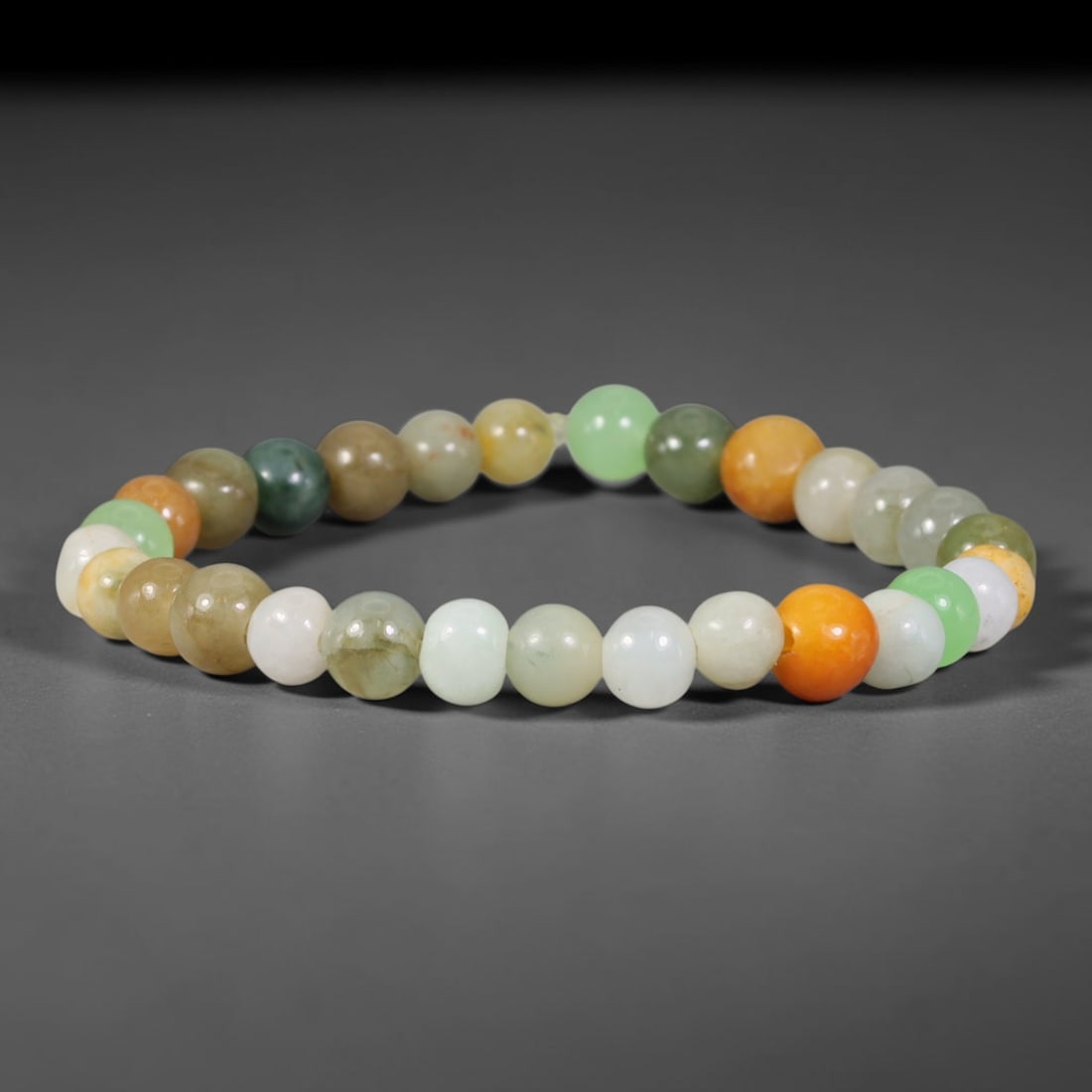 Natural Burmese Type A Earthy Multicolour Mixed Tone Round Jadeite Jade Beaded Bracelet, 46TP: Polished elastic strand bracelet hand-strung with genuine untreated Type A Burmese jadeite round beads, blending earthy mixed tones including pale celadon, milky white, warm honey yellow, amber orange