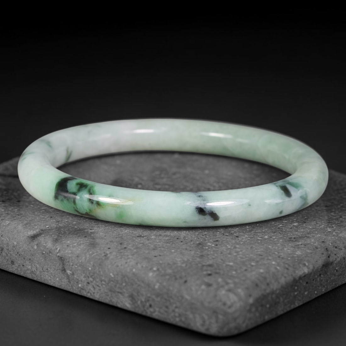 Natural Burmese Type A Floating Dark Green Veined Jadeite Jade Bangle Bracelet, 76TD: Crafted from natural Type A Burmese jadeite, this rounded bangle has a pale milky green base marked by striking floating dark green and near-black veined inclusions. It features a smooth rounded hoop 