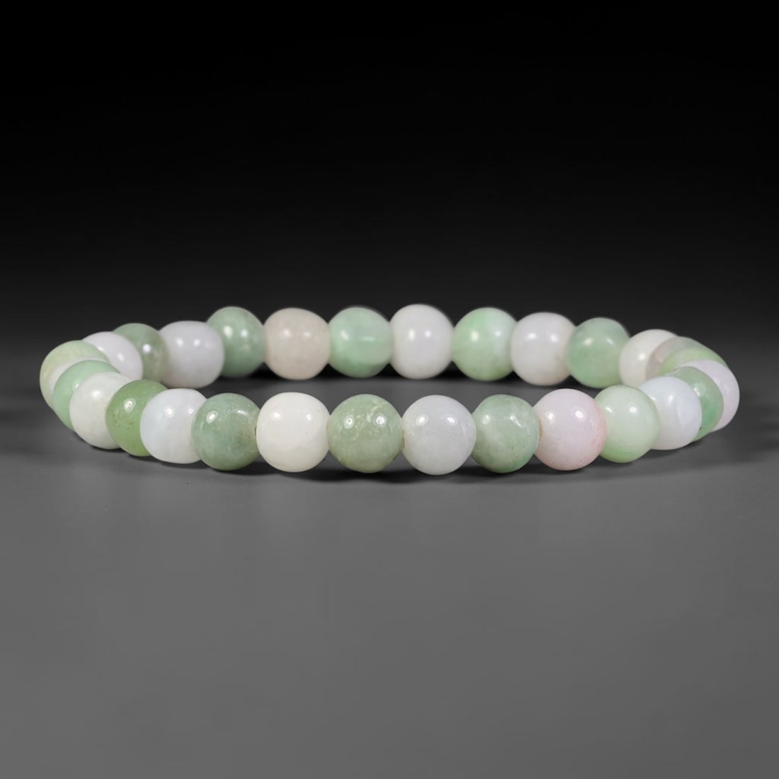Natural Burmese Type A Pastel Green White Pale Pink Jadeite Jade Bead Bracelet, 1TP: Strung from natural Type A Burmese jadeite, this slender spherical bead bracelet blends soft milky white, pale celadon green and subtle blush pink tones across uniformly polished beads. Each bead is c