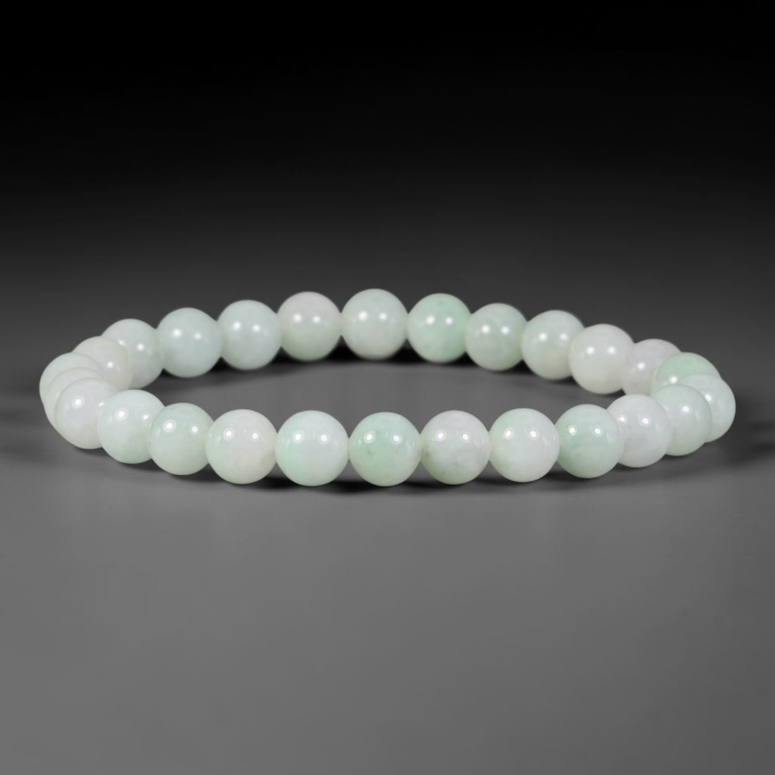 Natural Burmese Type A Pale Mint Celadon Jadeite Jade Bead Bracelet, 32TP: Strung from natural Type A Burmese jadeite, this spherical bead bracelet showcases a clean pale mint celadon tone with soft, evenly diffused light green hues across the beads. Each bead is smoothly po
