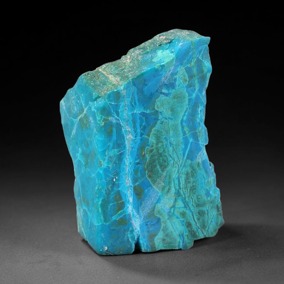 121.51ct Natural Peruvian Chrysocolla Polished Slab Rough, 86YS: This partial-polished chrysocolla slab features blended mineral matrix with smooth refined face and unaltered natural rugged edge across its 41x24x17mm elongated form, translucent mineral layers hold 