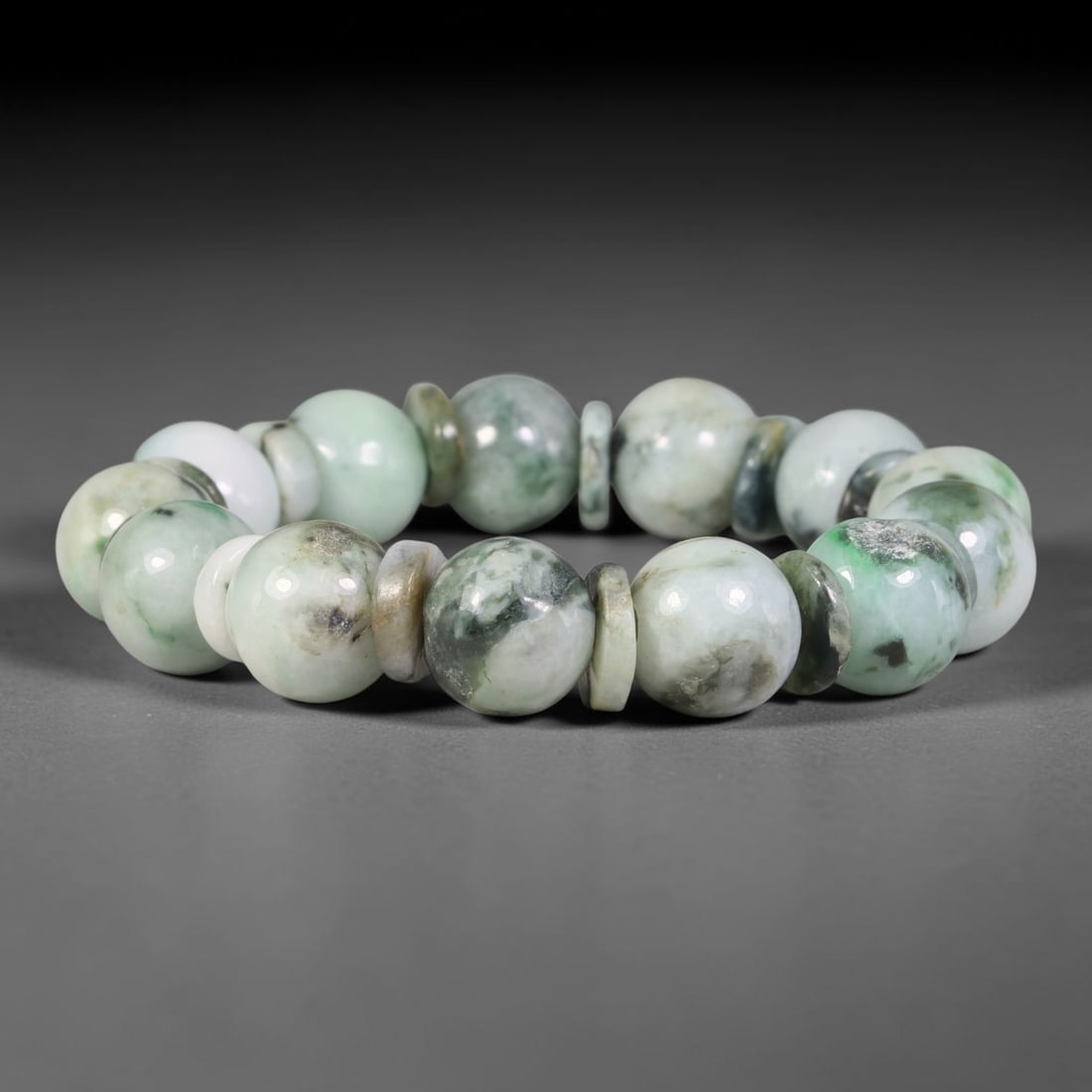 Natural Burmese Type A Cloud Mottled Green Jadeite Jade Bead Bracelet, 5TP: Strung from natural Type A Burmese jadeite, this large spherical bead bracelet features a pale creamy base adorned with soft cloud-like green and dark grey mottling, accented with thin multi-toned jad