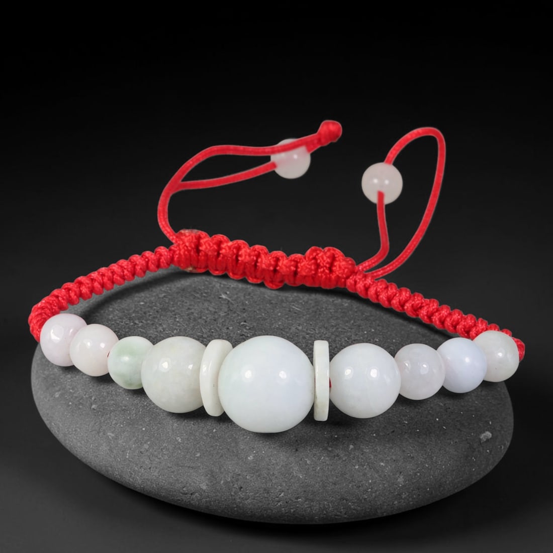 Natural Burmese Type A Milky White Graduated Jadeite Adjustable Red Braided Cord Bracelet, 22TP: Handcrafted adjustable red braided cord bracelet, featuring natural Type A Burmese jadeite graduated round beads in milky white with subtle pale celadon hints. Central large focal bead accented by tin