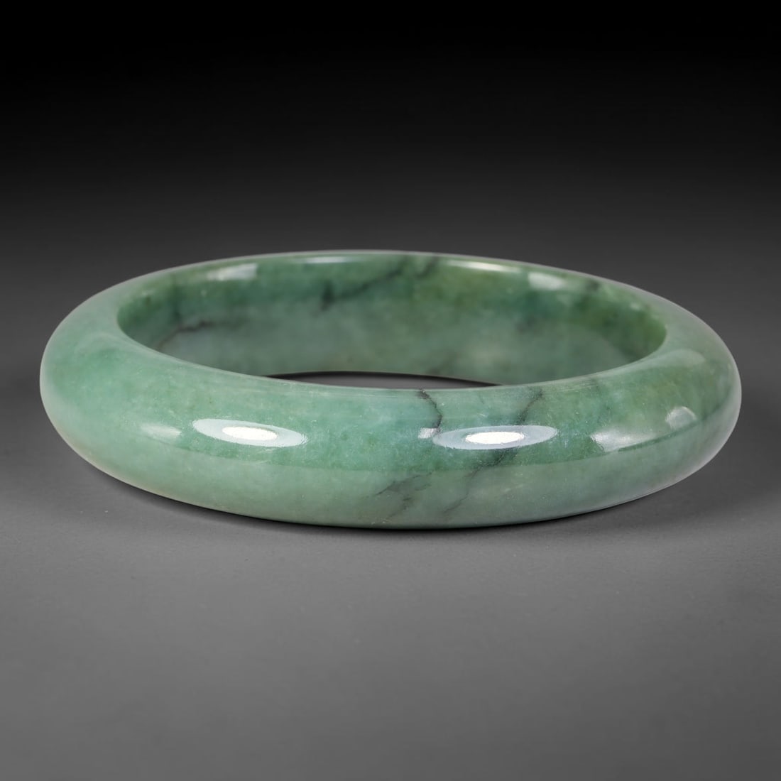 Natural Burmese Type A Variegated Floating Green Jadeite Jade Bangle Bracelet, 82TD: Genuine natural Burmese Type A jadeite jade bangle, with soft uniform seafoam green tone and delicate thin dark veining throughout. Smooth polished solid band, inner dimension 61.5x15.2mm. Natural sto