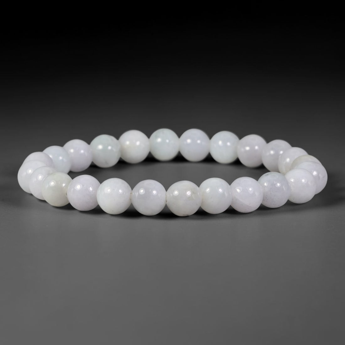 Natural Burmese Type A Pale Whitish Lavender Jadeite Jade Bead Bracelet, 25TP: Strung from natural Type A Burmese jadeite, this spherical bead bracelet has a gentle pale whitish lavender tone with faint diffused cloudy inclusions within each bead. Every bead is smoothly polished