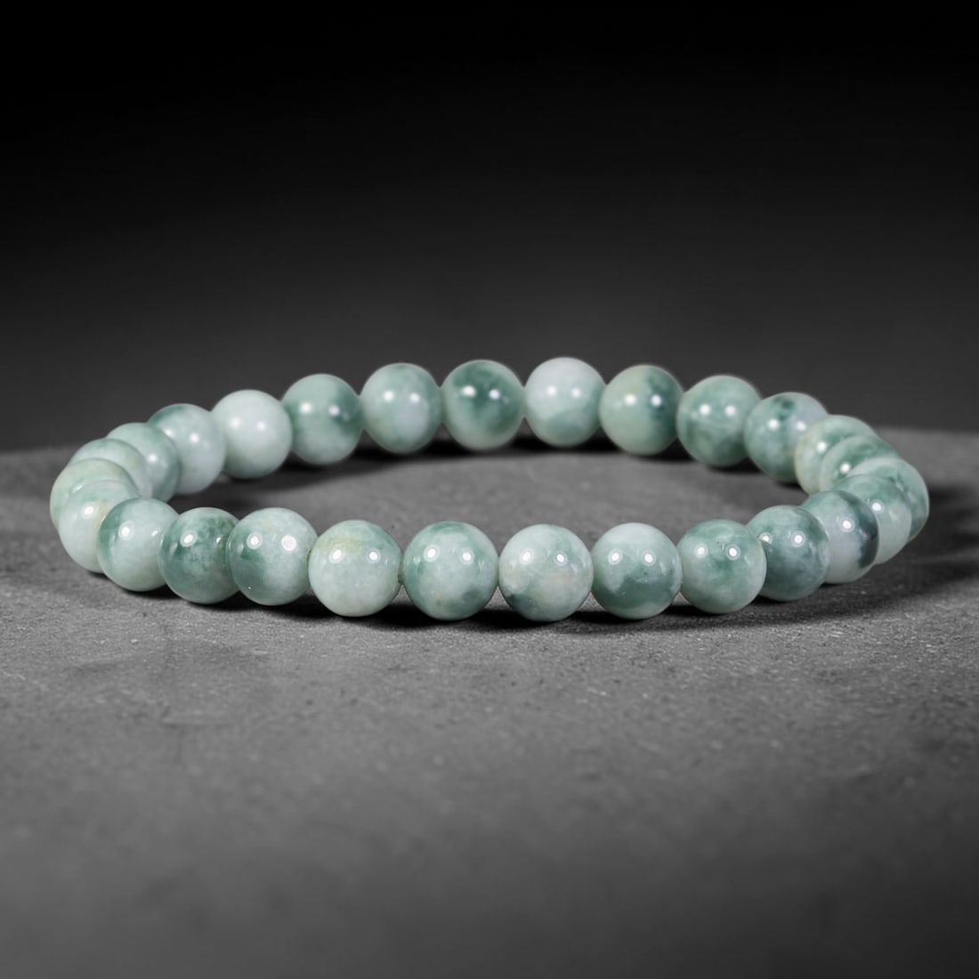 Natural Burmese Type A Floating Moss Green Jadeite Jade Bead Bracelet, 34TP: Strung from natural Type A Burmese jadeite, this spherical bead bracelet features soft pale celadon base with flowing floating moss green mottling across each bead. Every bead is smoothly polished and