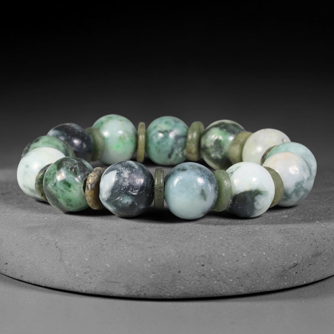 Natural Burmese Type A Variegated Dark Green Cloud Jadeite Jade Bead Bracelet, 7TP: Strung from natural Type A Burmese jadeite, this substantial spherical bead bracelet showcases a rich variegated palette of pale celadon, vivid emerald green and deep near-black cloud mottling, paired