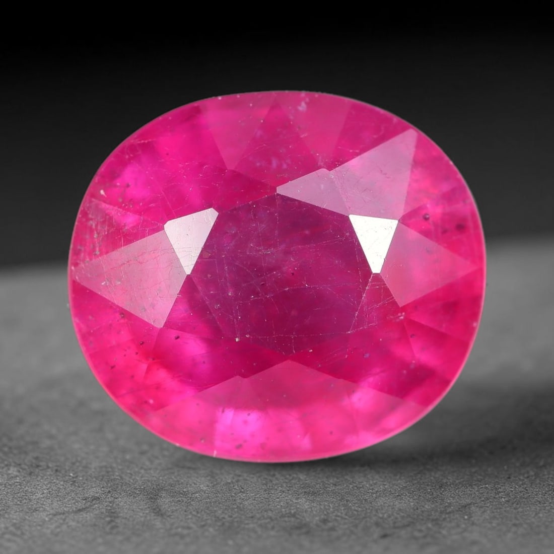 9.59 Carats Natural Mozambique Ruby Oval Faceted Loose Gemstone, 85TH: This natural Mozambique ruby is fashioned with standard oval brilliant faceting, displaying vivid saturated crimson-red hue accompanied by native fine mineral inclusions and subtle trace marks inheren