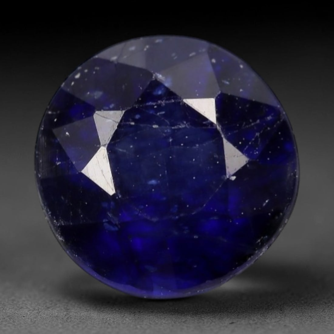 1.74ct Natural Vivid Royal Blue Round Brilliant Sapphire Loose Faceted Gemstone, LZ306: This natural round faceted sapphire weighs 1.74 carats with calibrated dimensions of 6.5mm diameter and 4.6mm depth. It exhibits an intensely saturated vivid royal blue hue with subtle soft grey-blue 