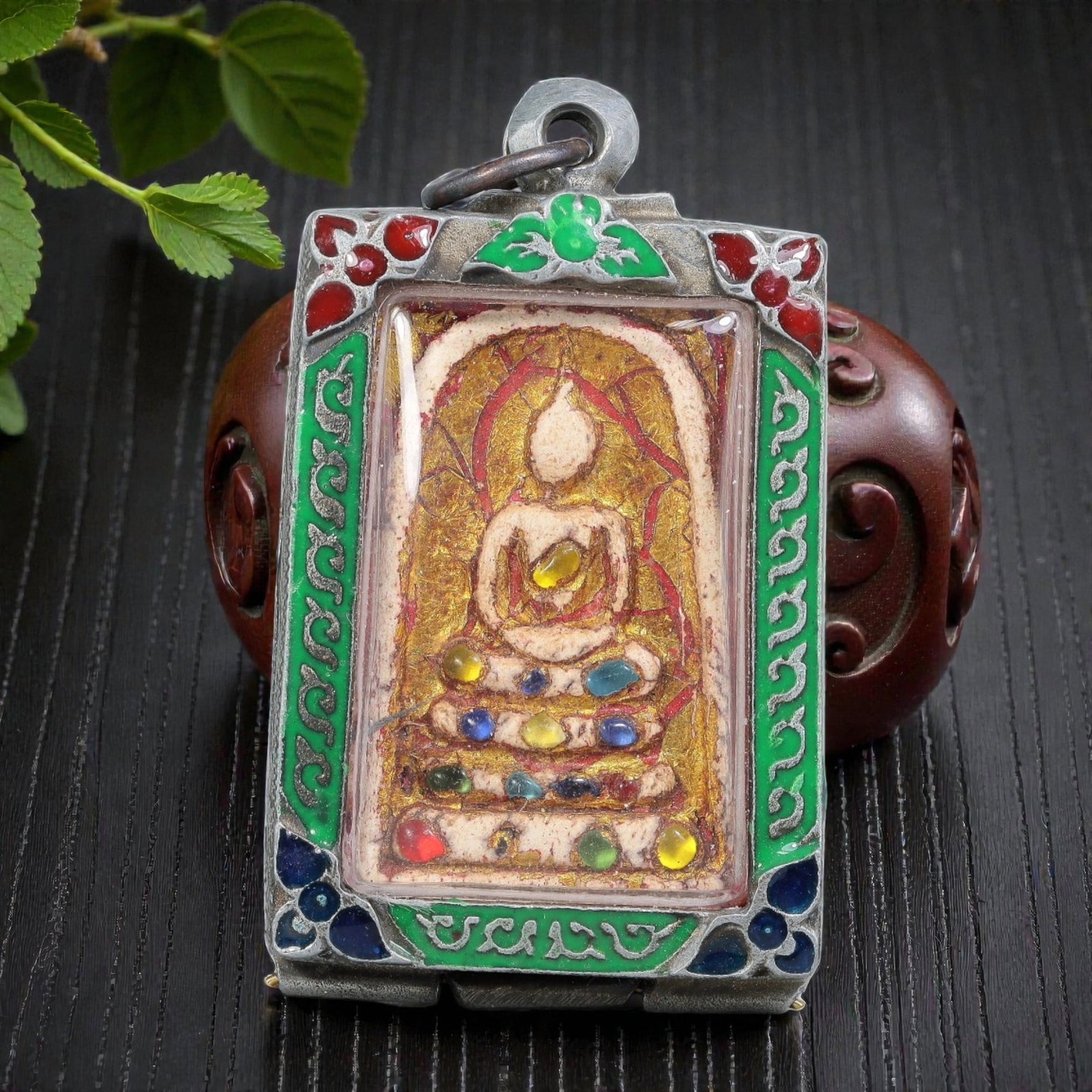 Thai Phra Somdej Amulet - Multicolored Enamel Silver Tone Pendant, 63ZB: A Thai Buddhist Phra Somdej amulet featuring a seated Buddha figure on tiered bases, housed in a silver-tone metal casing with vibrant multicolored enamel detailing. The glass-fronted enclosure protec