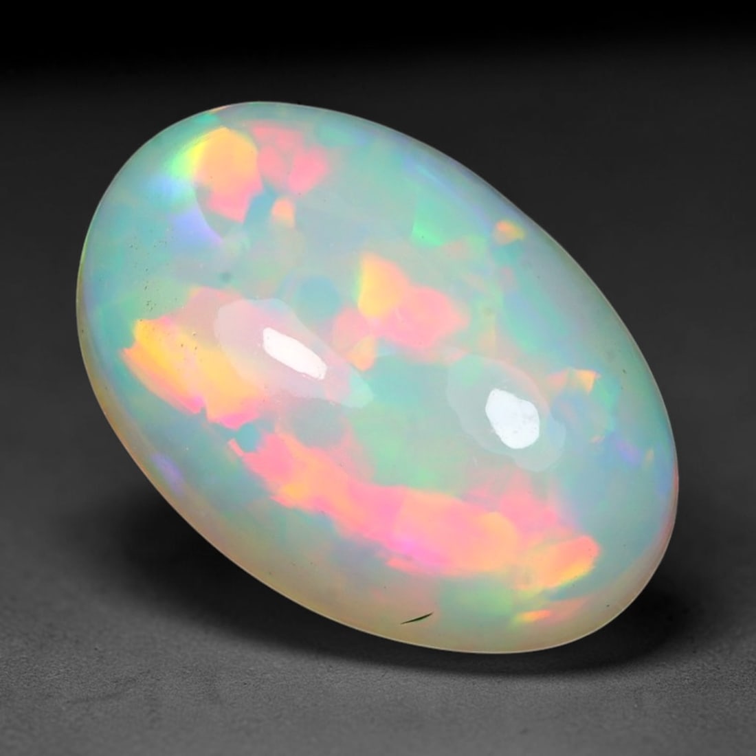 3.48ct Natural Ethiopian Welo Solid Opal Oval Cabochon Loose Gemstone, 35TG: Solid opal cabochon mined from Ethiopia's Welo opal deposits, polished into a smooth elongated oval dome with high reflective gloss. The translucent pale milky base hosts broad shifting play-of-color 