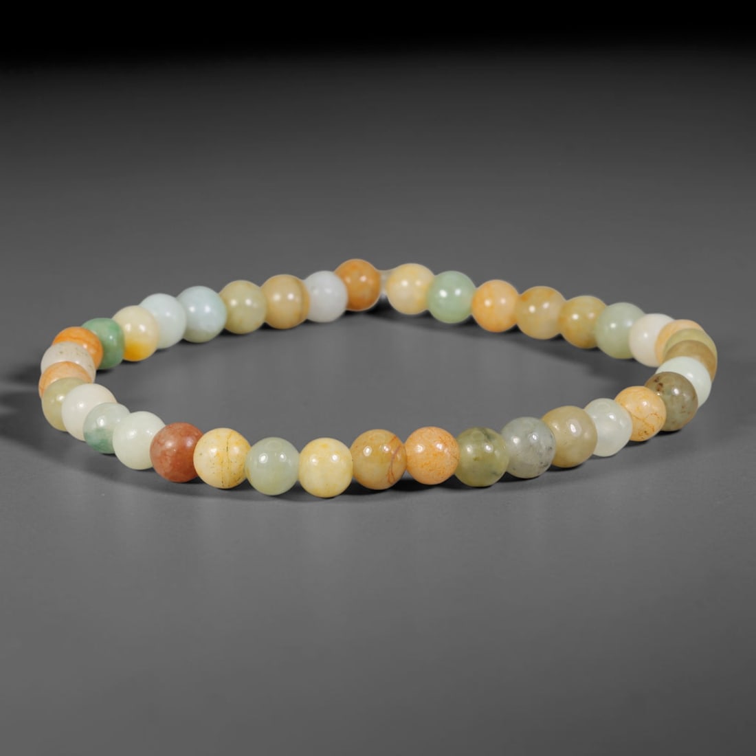 Natural Burmese Type A Multi-Colour Jadeite Jade Beaded Bracelet, 38TA: Strung from untreated natural Burmese Type A jadeite jade spherical beads with maximum bead dimension of 6.21mm, this bracelet strand features a sleek smooth polished finish showcasing mixed pale gree