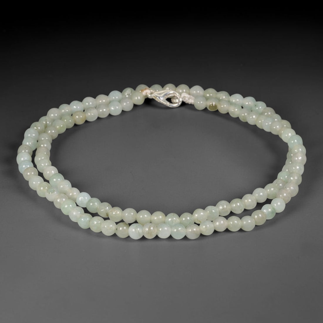 Natural Burmese Type A Pale Mint Green Jadeite Jade Bead Necklace, 16TF: Smooth round natural Burmese Type A jadeite beads measuring 5.7mm, showcasing delicate pale mint green tones with subtle natural colour shifts across the strand. Secured with a sterling silver lobster