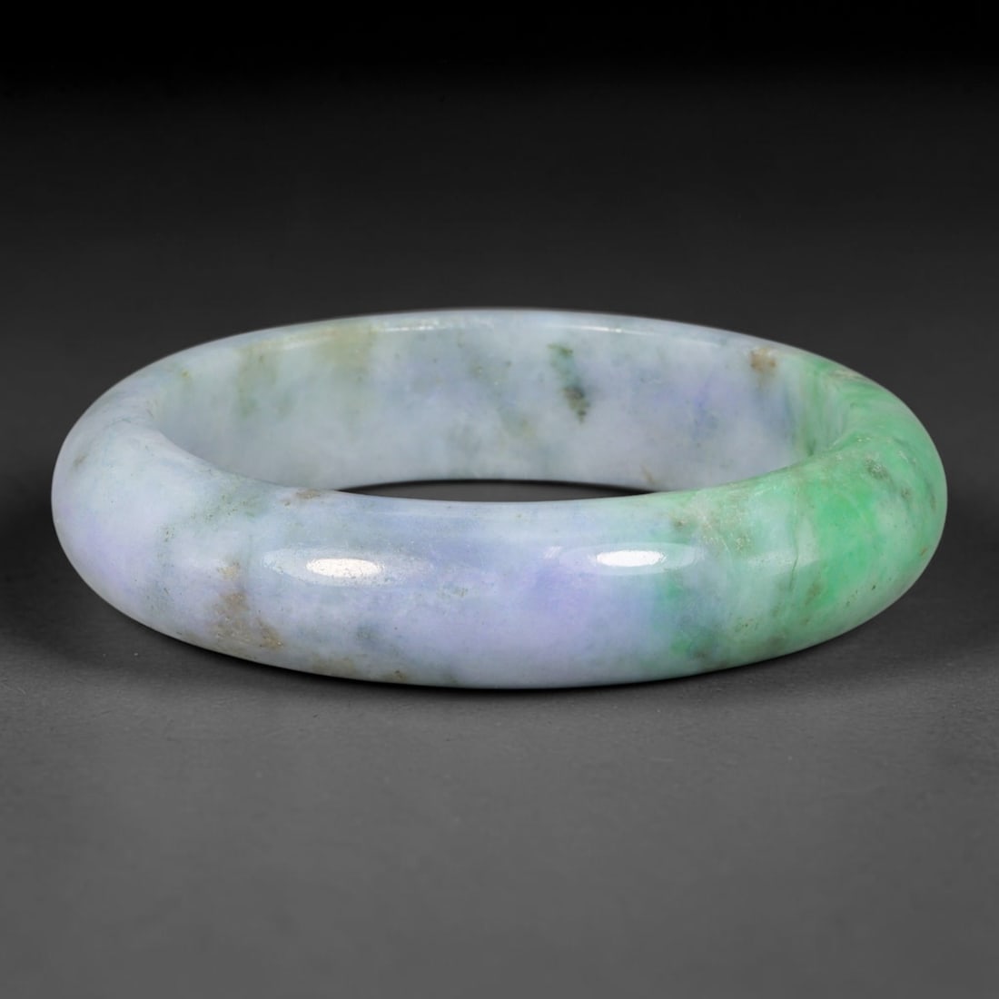 Natural Burmese Type A Jadeite Jade Bangle Bracelet, 9TD: Crafted from natural Burmese type-A jadeite, this thick wide-wall bangle features soft diffused lavender-lilac tones merging into a vibrant bright green section along one side of the band. Faint earth
