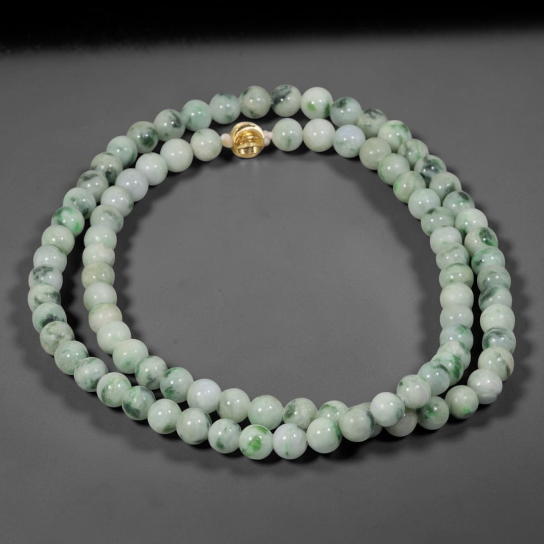 Natural Burmese Type A Pale Floating Jadeite Jade Beaded Necklace, 11WY: Constructed from unprocessed Burmese Type A jadeite stone, each spherical bead displays soft scattered green mineral flecks naturally integrated into the pale stone matrix through geological formation