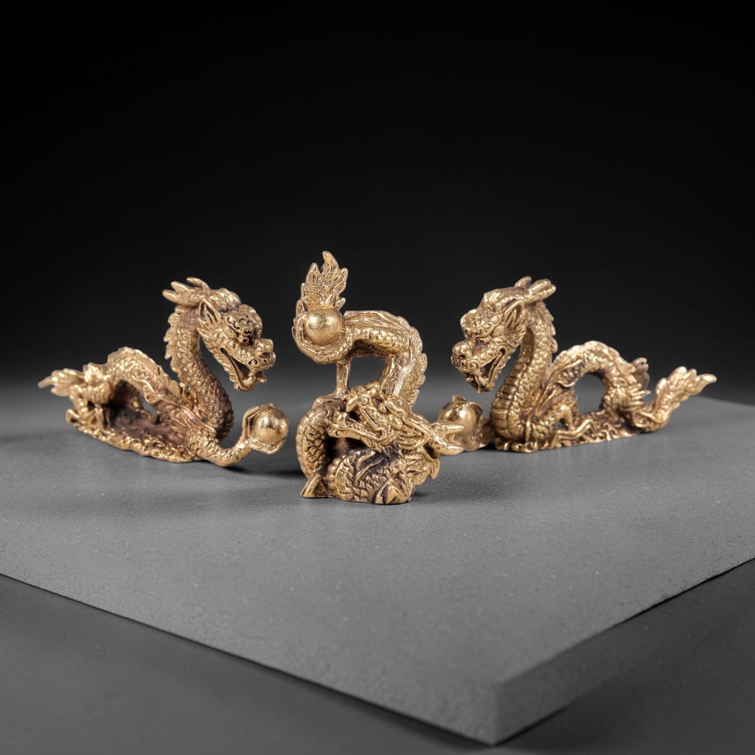 Thai Vintage Copper Alloy Sacred Dragon Devotional Figures - 3pcs Set, 91YY: Mini vintage copper alloy dragon statuette set of three pieces, each measuring 4.7x2.5cm. The set features intricately carved golden dragons clutching pearl orbs, showcasing detailed scale, mane and c