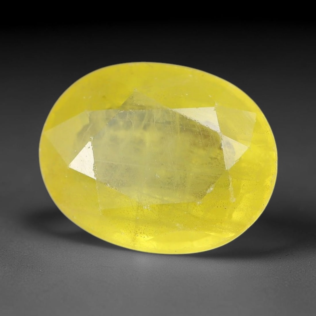 3.17 Carats Natural Yellow Sapphire Oval Faceted Loose Gemstone, 50XM: This natural yellow sapphire features a classic oval brilliant faceted cut, holding consistent warm golden-yellow color throughout the corundum crystal. Fine microscopic mineral specks and faint natur