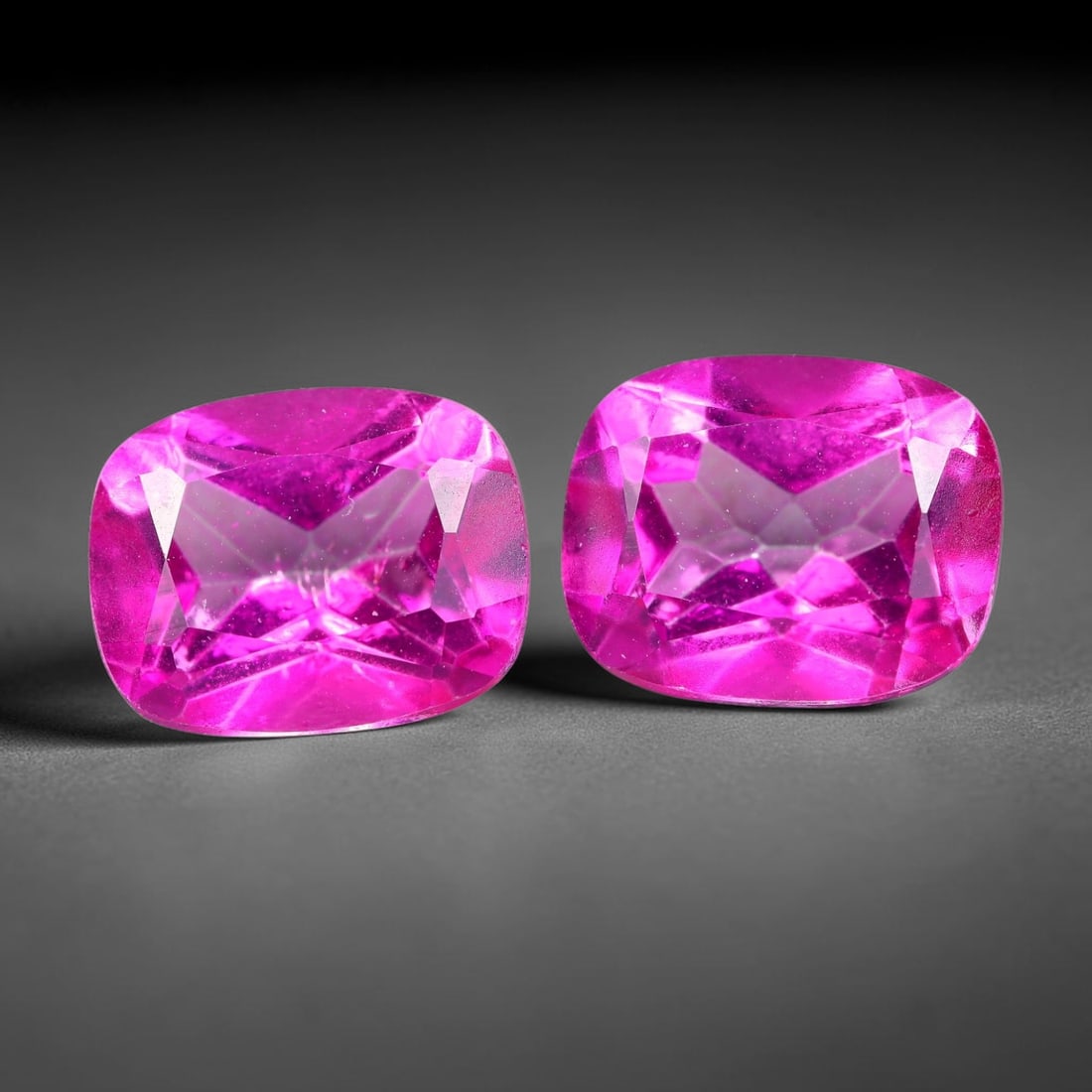 7.30ct Natural Pink Topaz Cushion Cut Matched Pair Loose Gemstones, 89TG: Natural pink topaz fashioned into a matched pair of cushion mixed cuts with polished table and brilliant pavilion facets. The stones display a saturated vivid hot pink body color with excellent transp