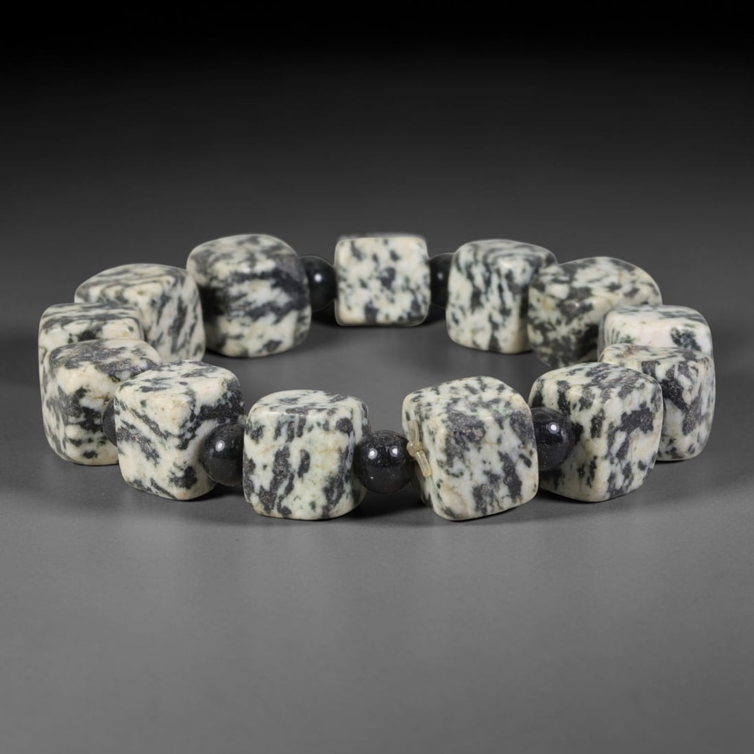Natural Black White Dendritic Jasper Cube Beaded Bracelet, 40TA: Handcrafted bracelet made of natural dendritic jasper rounded square cube beads with unique natural black moss dendritic veining spread over off-white base. Each cube is separated by polished black ob