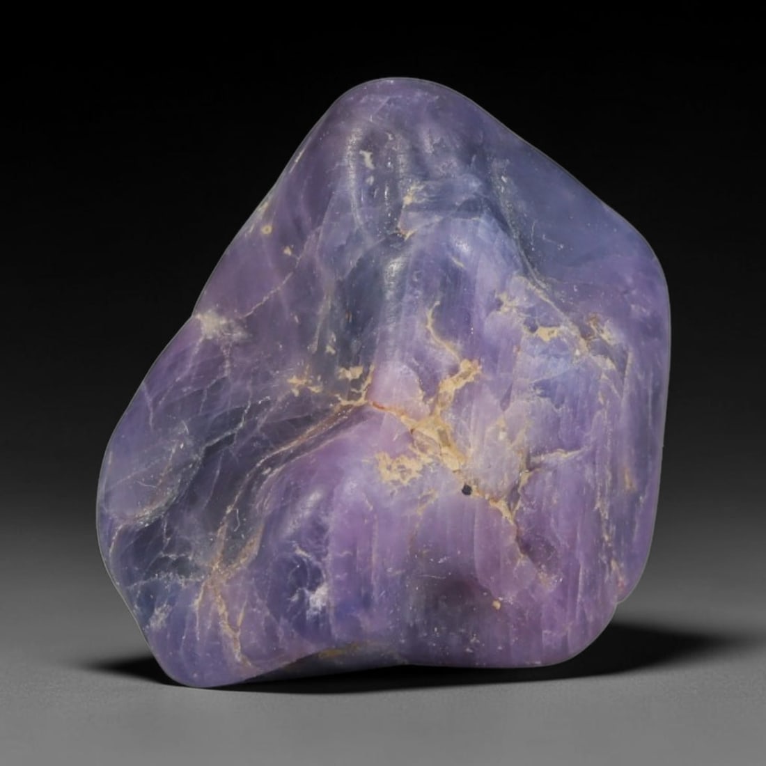 24ct Natural Unheated Sri Lankan Purplish Blue Sapphire Rough, 90YQ: This natural corundum rough is an unheated purplish blue sapphire sourced from Sri Lankan alluvial gem deposits, featuring an irregular natural native form with residual pale yellow-brown mineral matr