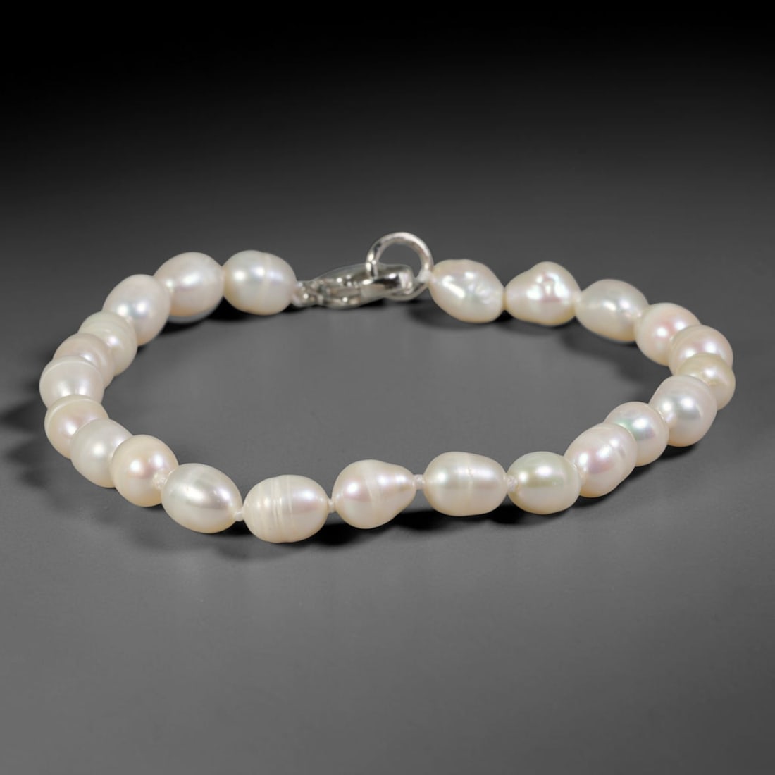 Natural Freshwater Pearl Bracelet - Slim Baroque Milky White Pearl Strand, 74YM: Crafted from petite organic baroque natural freshwater pearls with gentle milky white pearlescent iridescence, each bead features slim asymmetrical barrel and oval silhouettes formed through natural p