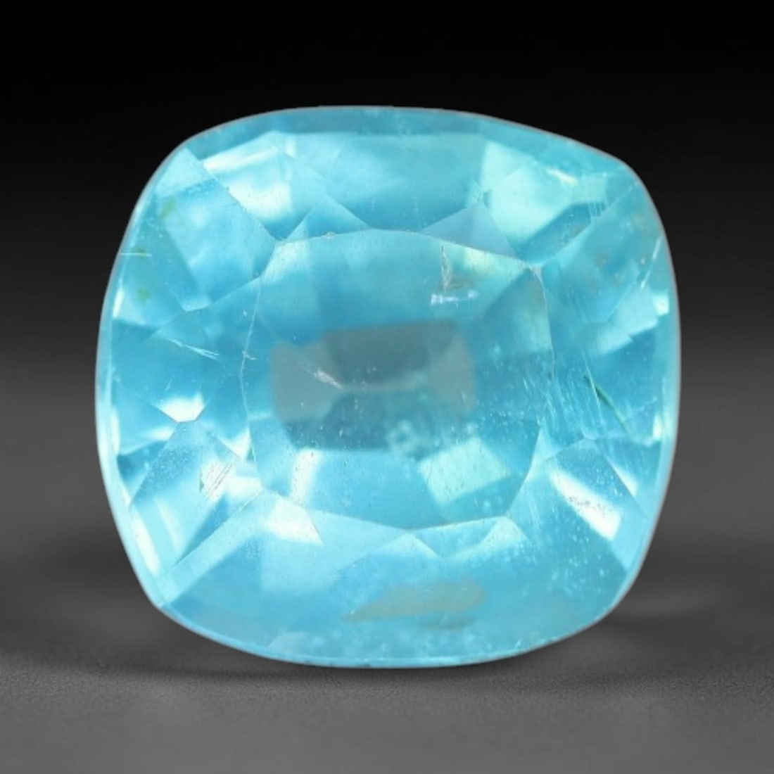 1.45 Carats Natural Bright Cyan Blue Apatite Cushion Faceted Loose Gemstone, 15WW: This apatite is sourced from natural mineral deposits and processed with precise faceting and uniform high-gloss polishing by professional lapidary craftsmanship. Natural fibrous textures and tiny sca